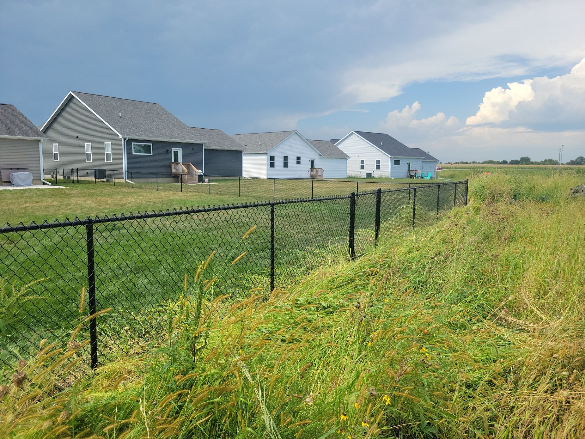Residential Black Chain Link Fence Installation in Jesup by Perfect Picket Fence and Stain