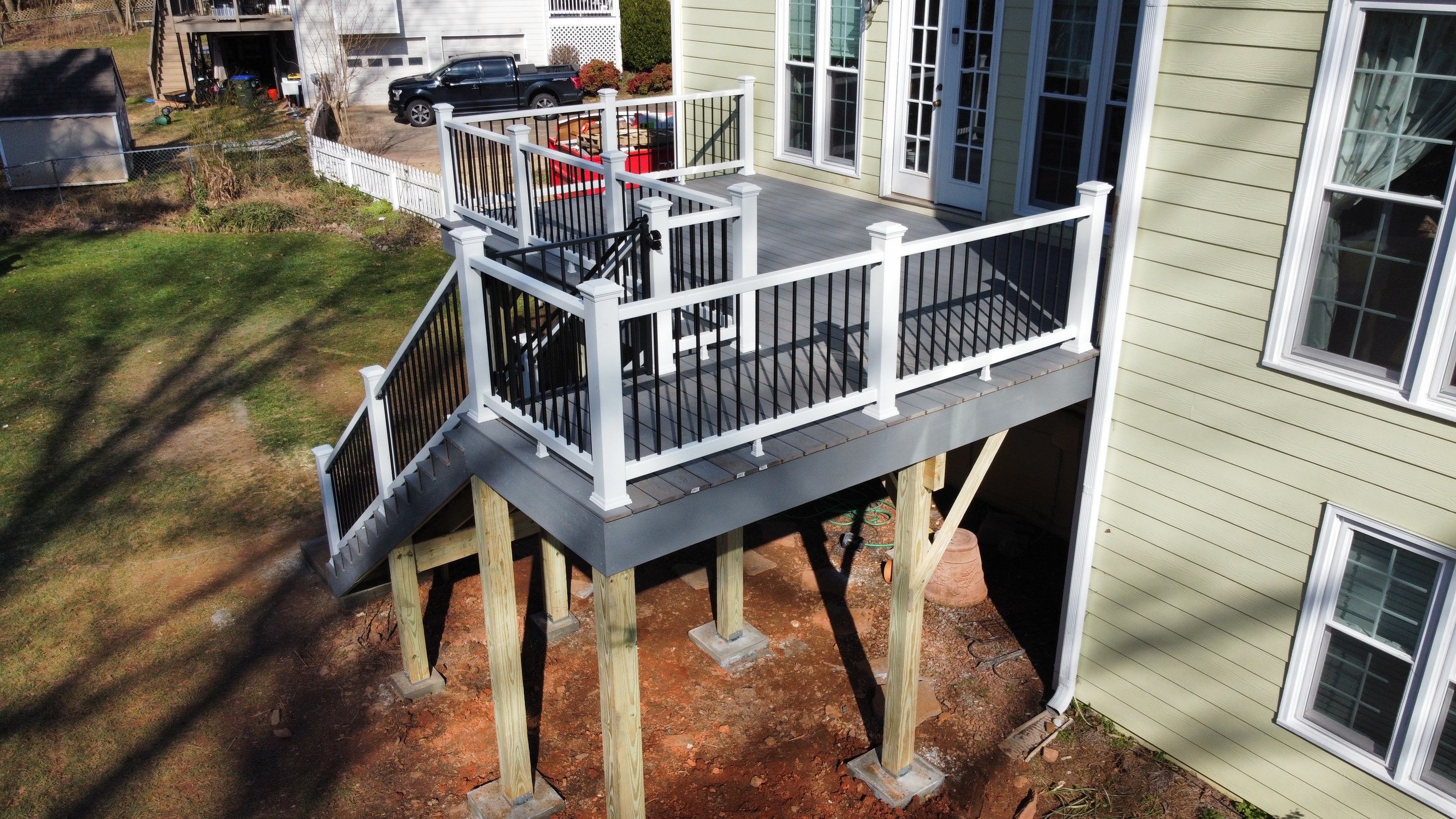Elevated Grey Composite Deck Installation in Woodstock, Georgia by Swift Home Renovations