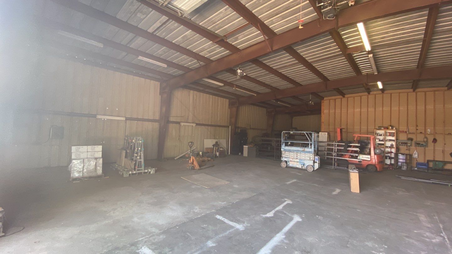 Spray foam insulation on inside of metal industrial building by Straight Edge Roofing Inc