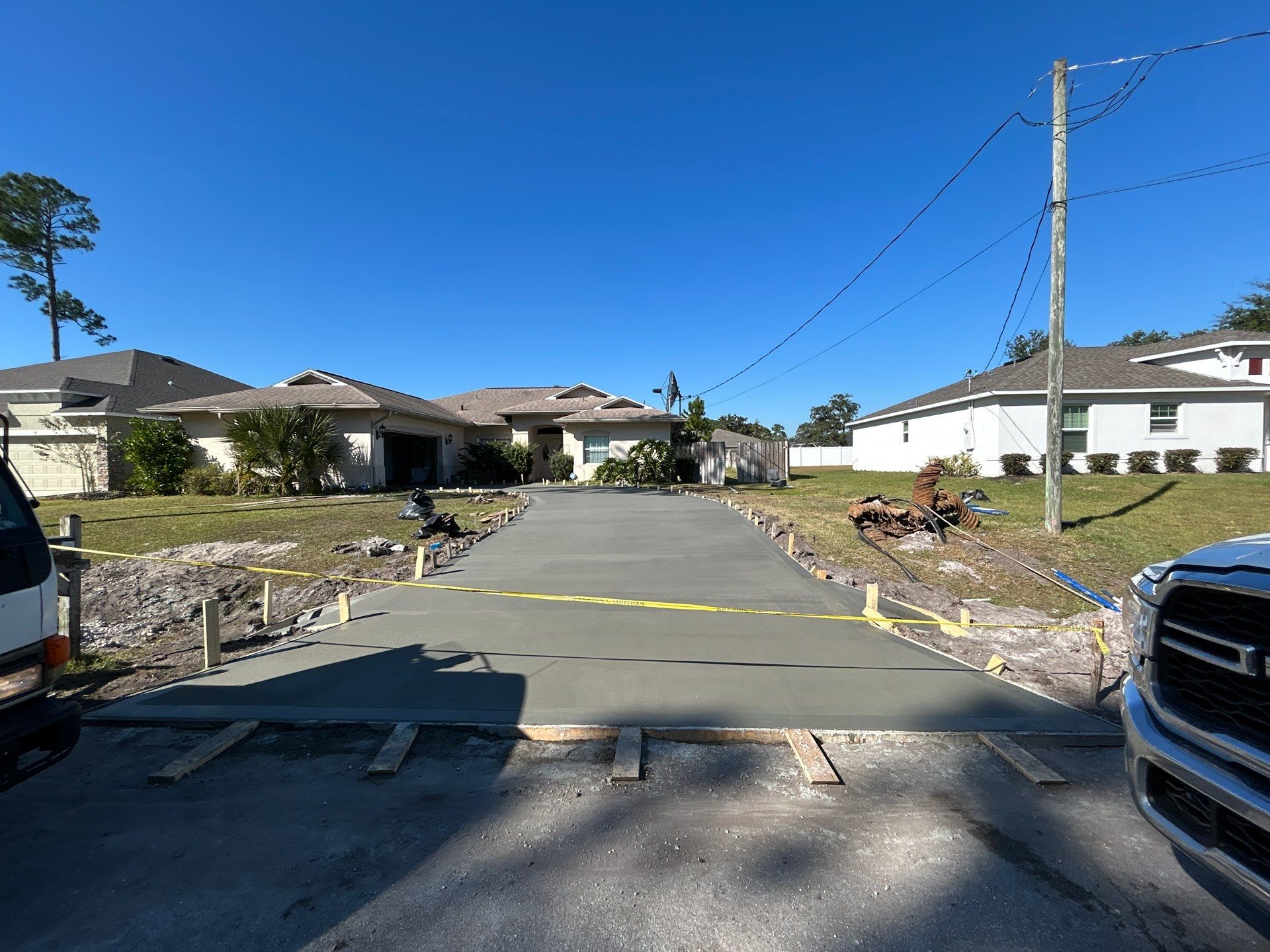 New concrete driveway by Courtesy screening