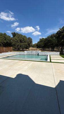 Geometric Pool with Stacked Stone Water Wall