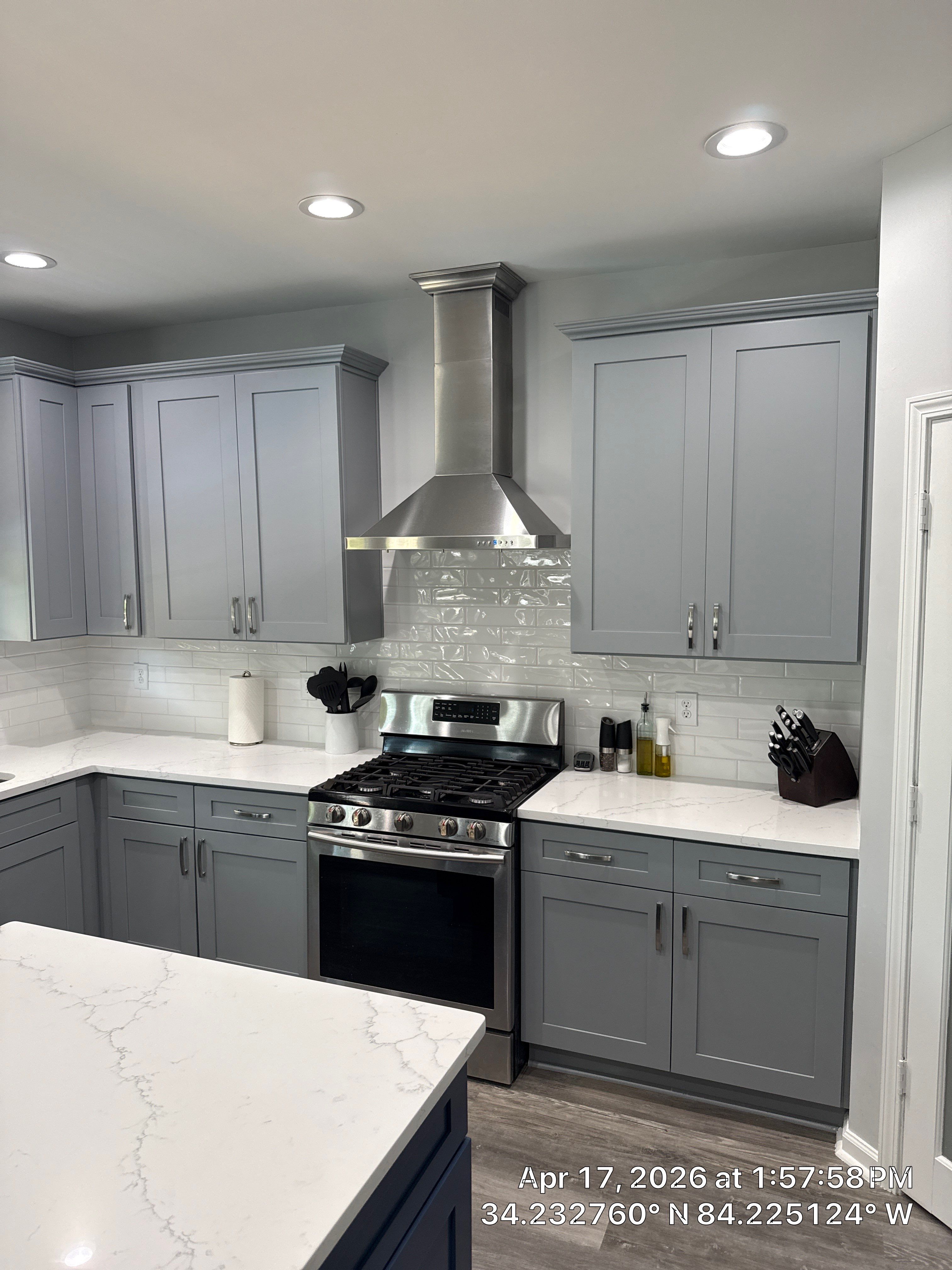 Modern Kitchen Remodel With Grey Shaker Cabinets and Navy Blue Island by Heart & Home Kitchen & Bath Remodeling LLC
