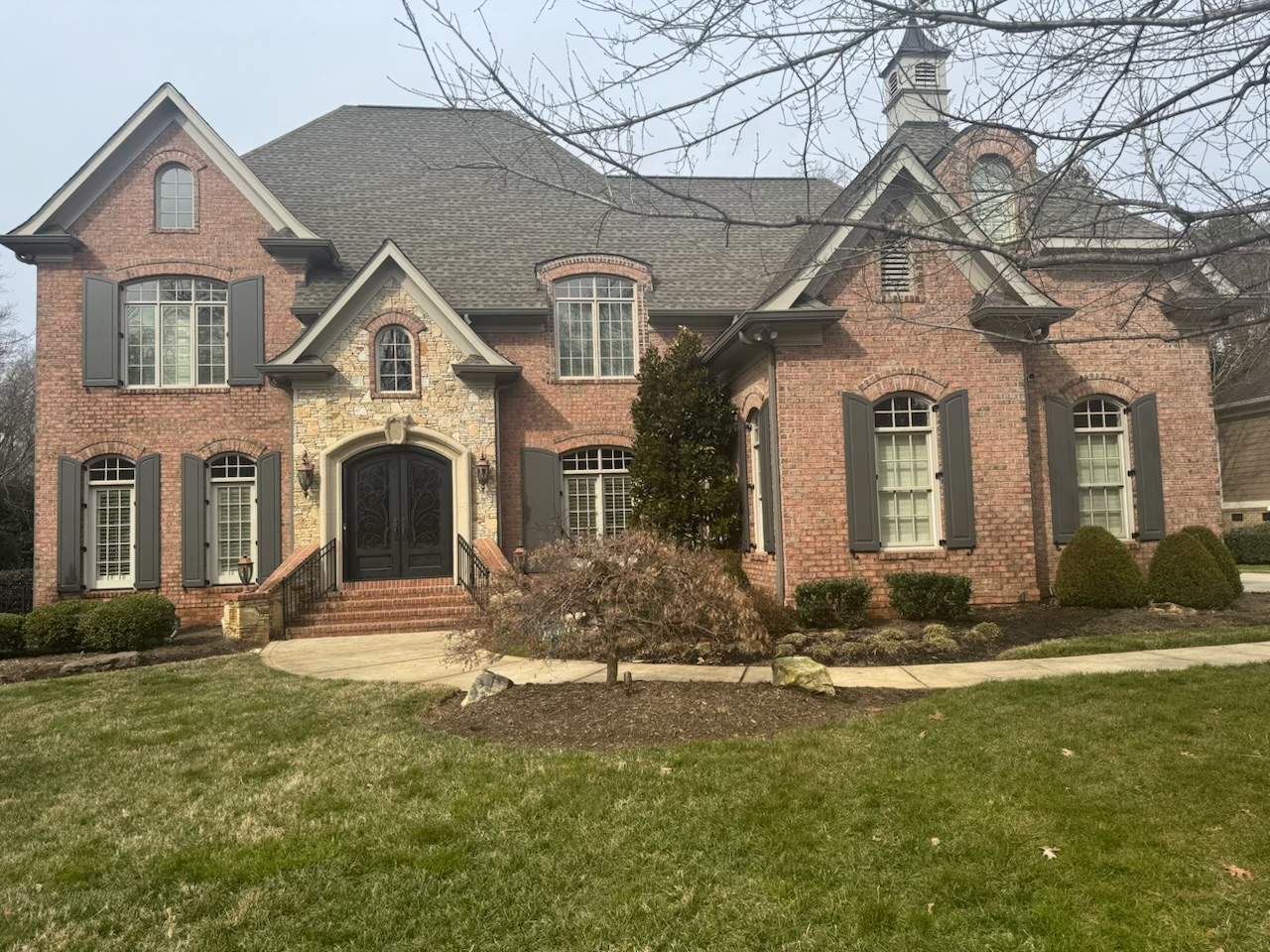 Exterior raised panel shutters by Southern Traditions Window Fashions