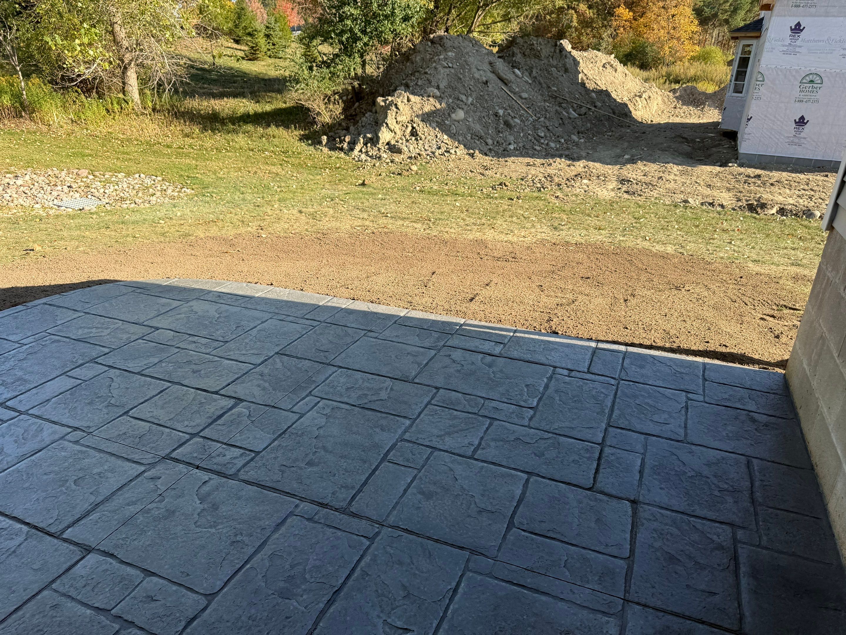Stamped English Rivenstone concrete patio and sidewalks  by NG Masonry & Construction LLC