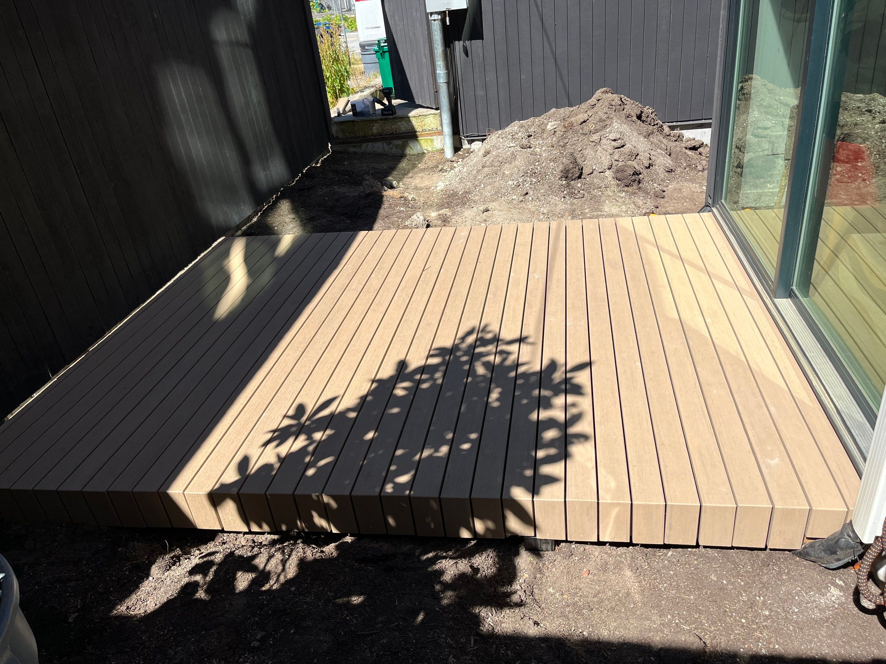 Modern Backyard Deck by Alki deck builders 