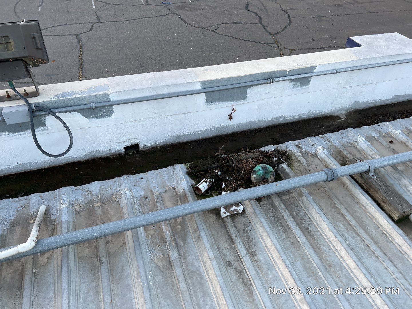 Metal roof restoration on commercial roof using Conklin Benchmark/ PUMA XL acrylic coatings over metal and foam by Straight Edge Roofing Inc