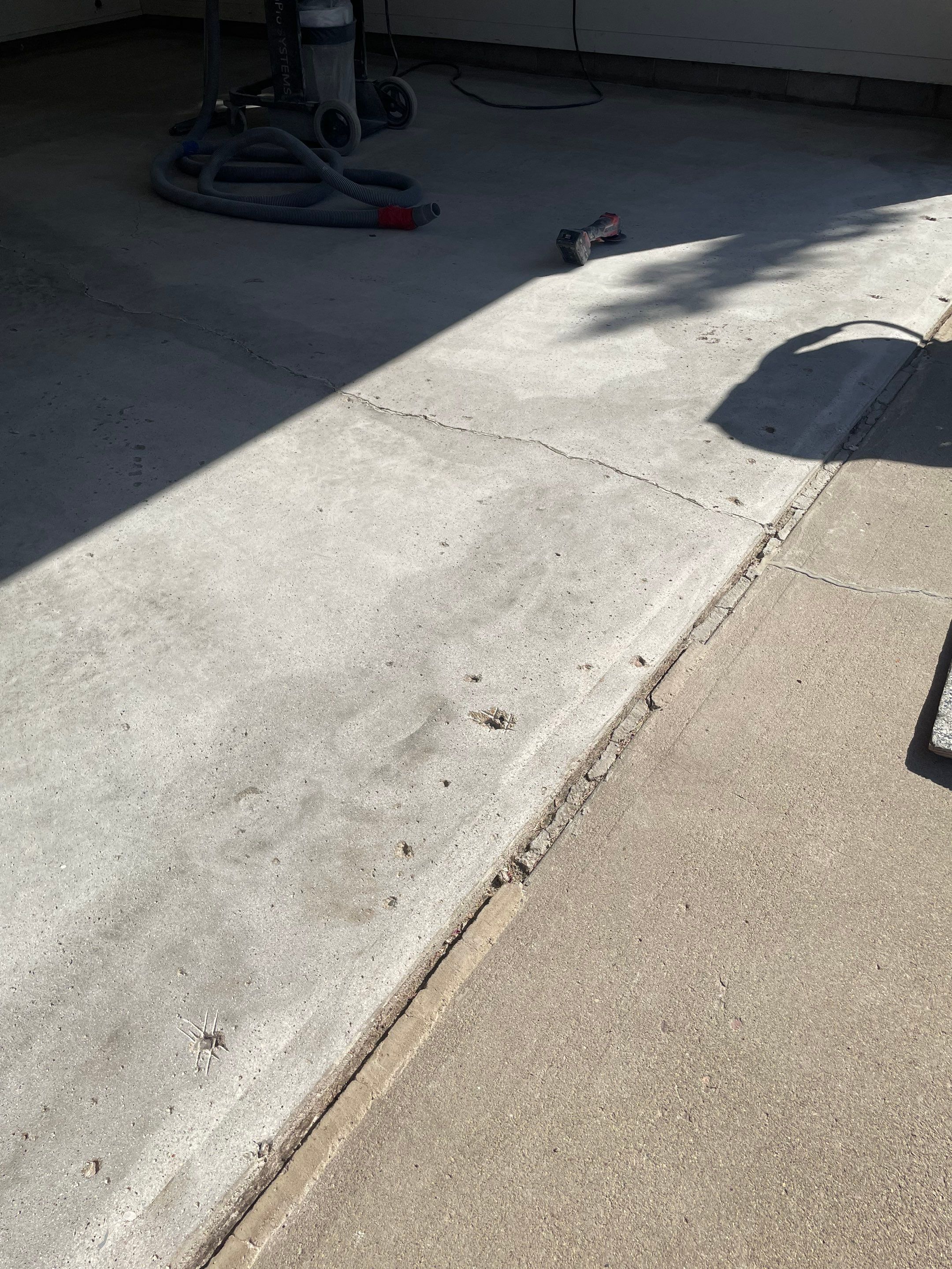 Grey Speckled Concrete Coating for Residential Garage in Yankton by Select Painting, Coatings & Garage Cabinets