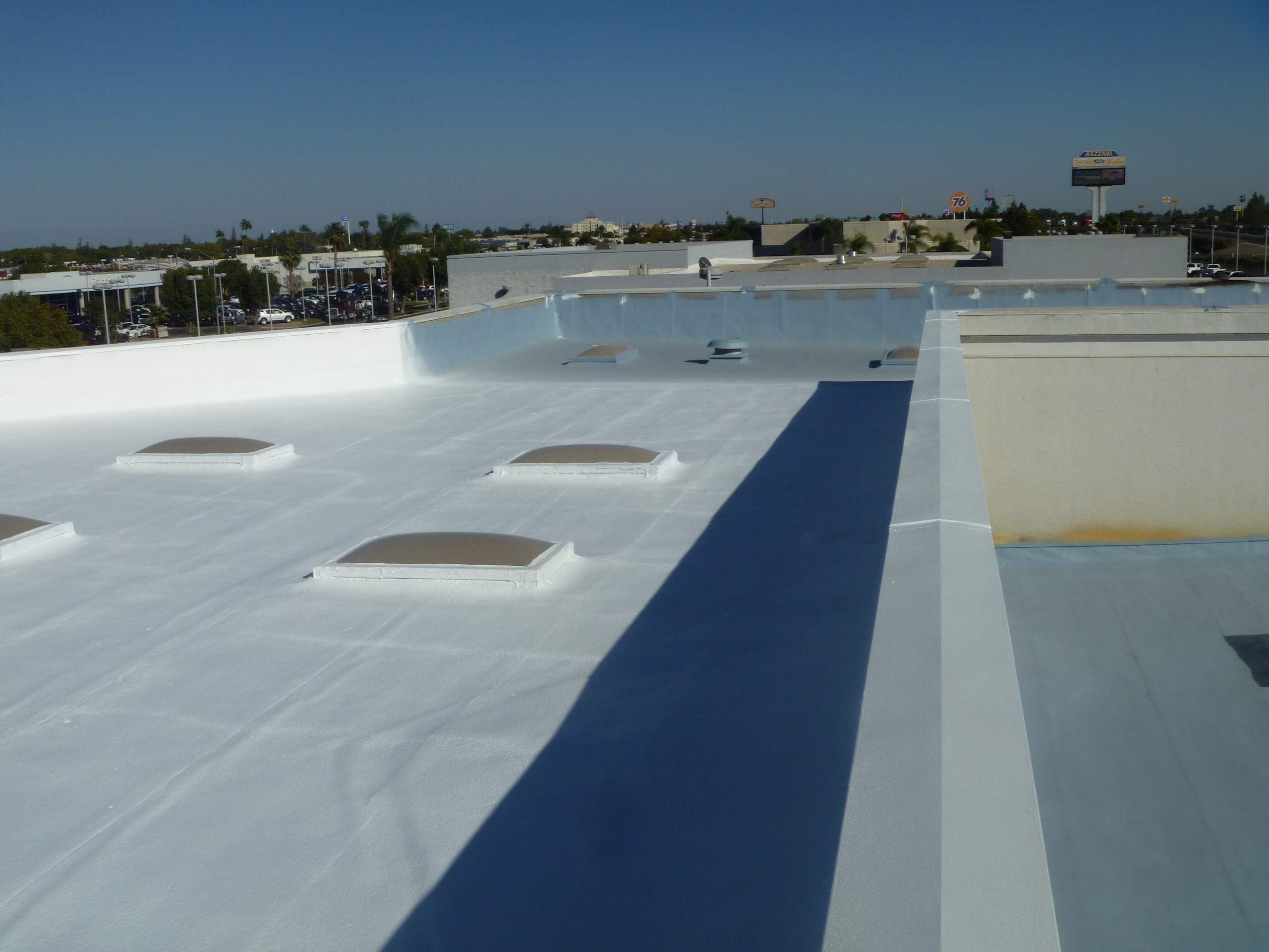 Commercial Roofing Installation using Spray foam and Conklin Benchmark/PUMA XL 18 yr warranty coatings by Straight Edge Roofing Inc