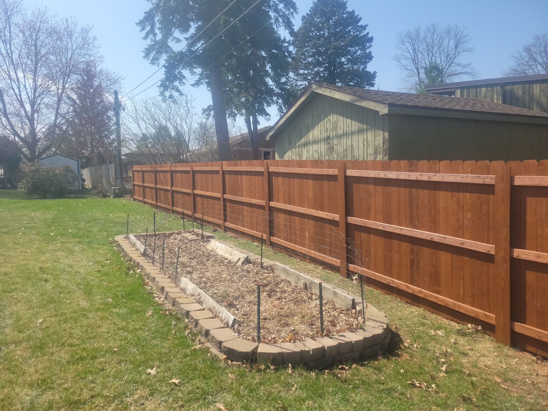Stained Cedar Wood Privacy Fence Installation in Cedar Falls by Perfect Picket Fence and Stain
