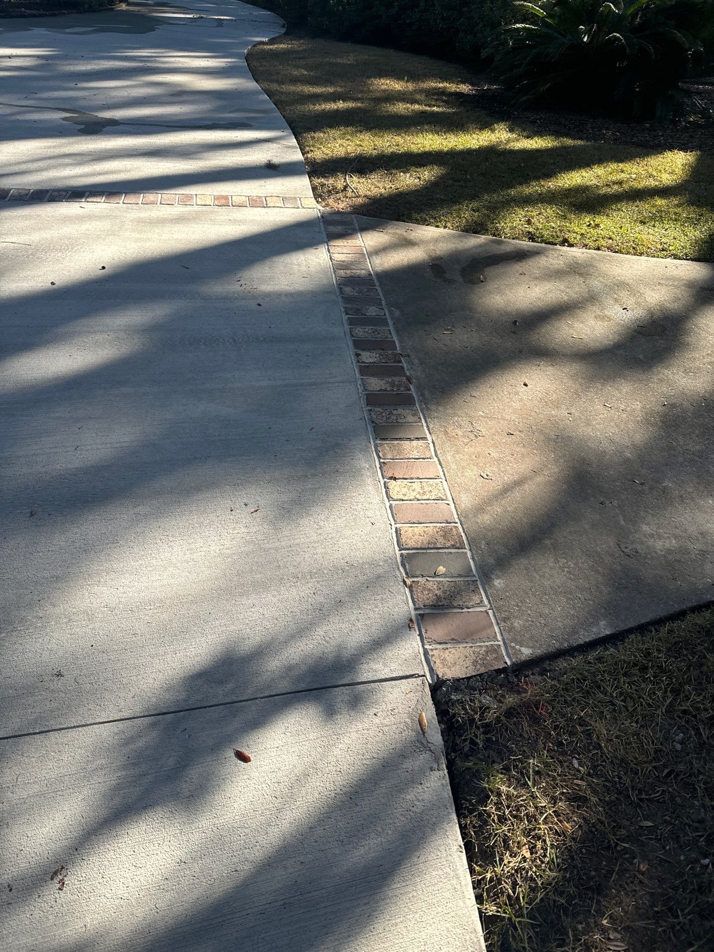 Custom Concrete Driveway Installation with Decorative Brick Borders in Okatie by Lowcountry Scapes, LLC