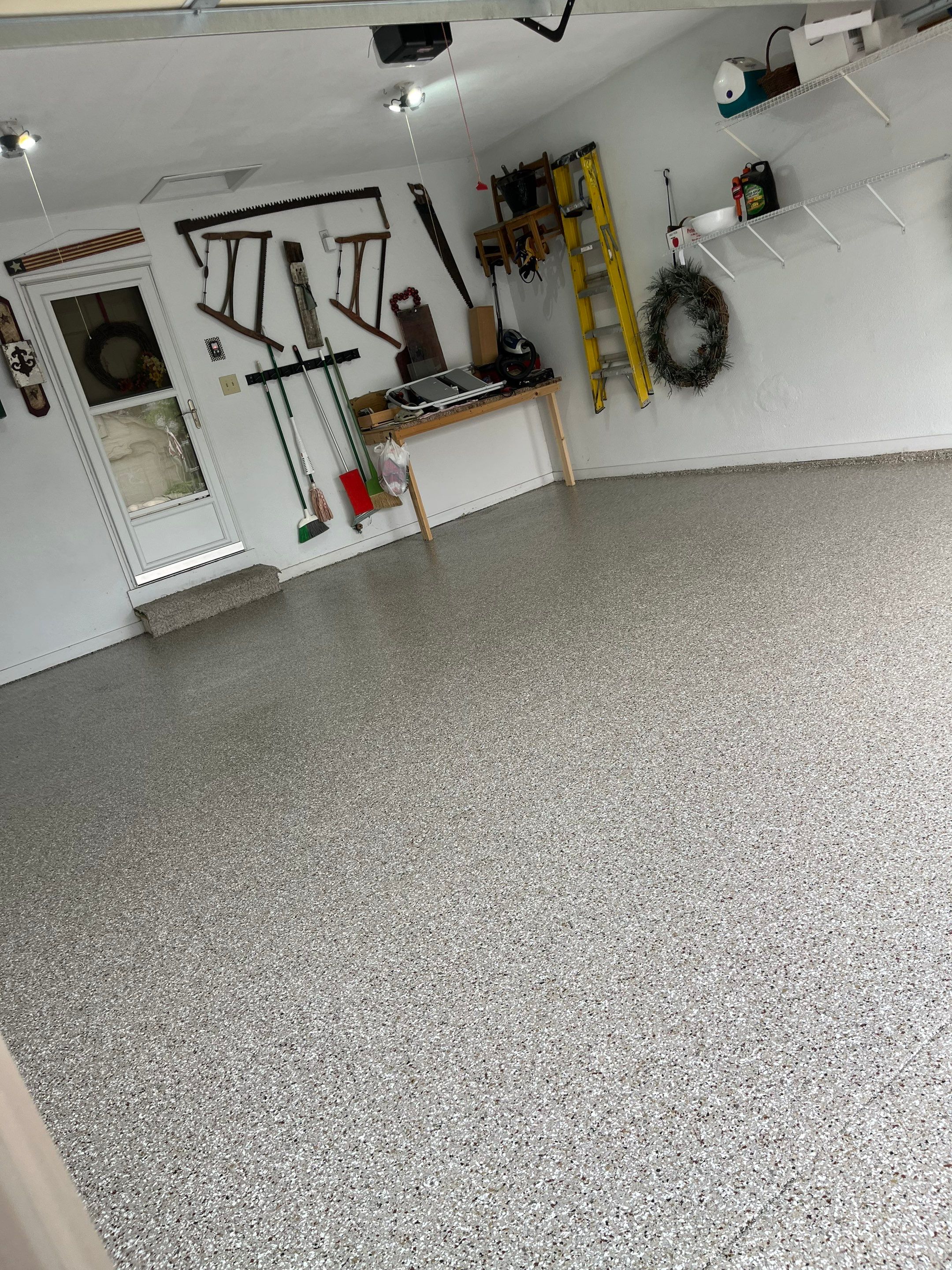 West Des Moines Garage and Patio Floor Coating using Pebble Beach Flakes by Revival Concrete Coatings
