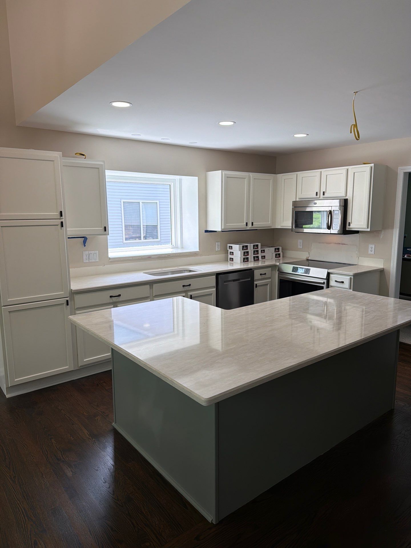 Two-Tone Kitchen Cabinet Refinishing in Sage Green and White by Top Shelf Painter