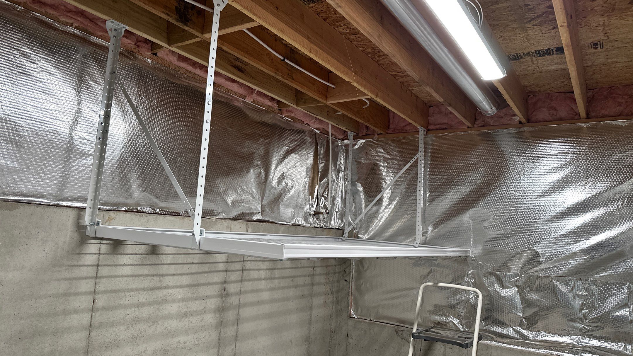 Brandon C. added these overhead racks to upgrade his storage  by Banner Garage