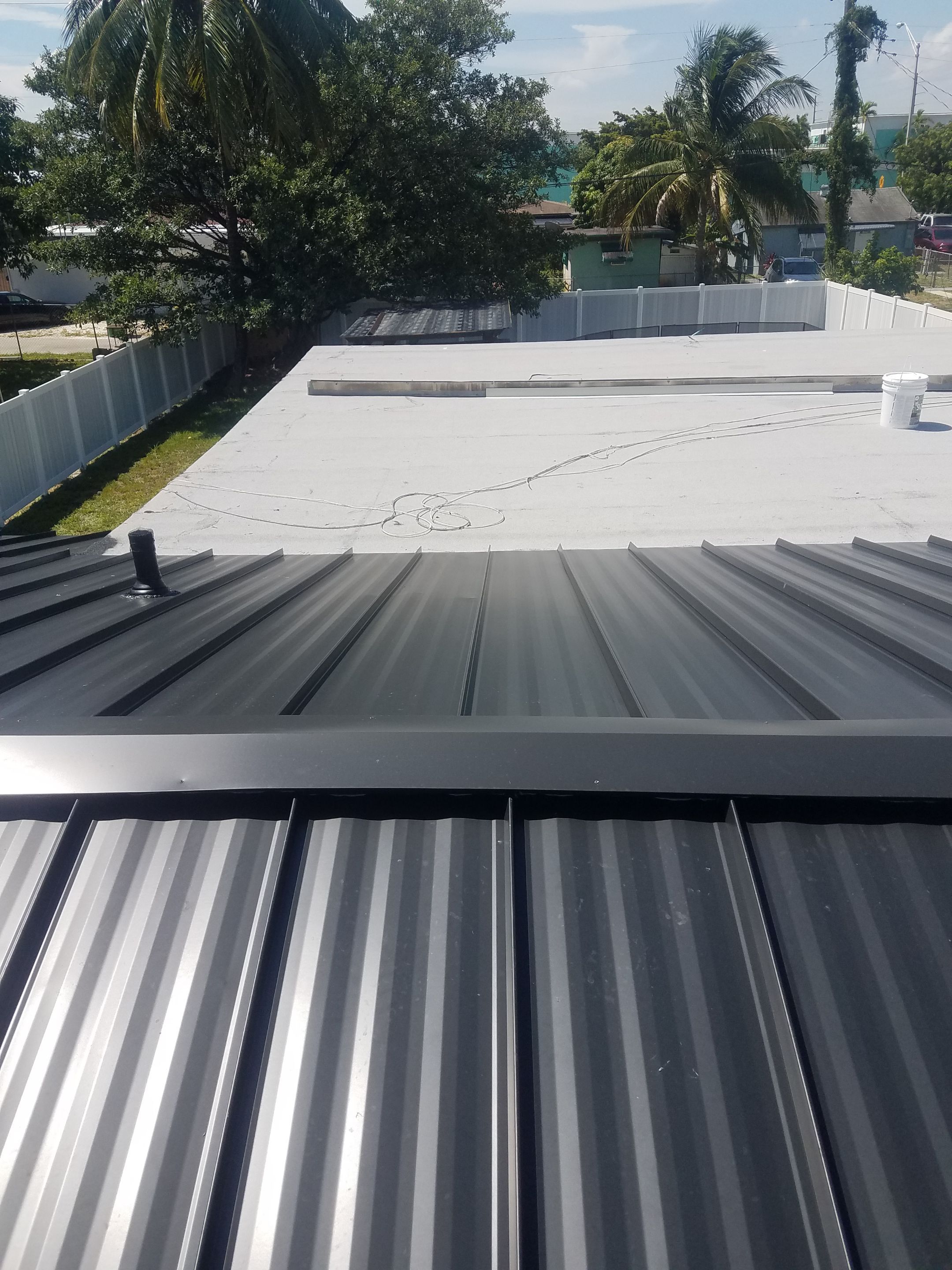 Standing Seam Metal & Flat Re-Roof using 1.5" Nail Strip 24ga Black Matte Kynar Coated Standing Seam Metal Panels by Morton Roofing, Inc.
