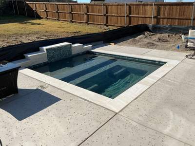 Geometric Pool and Spa with Dark Pebble Interior