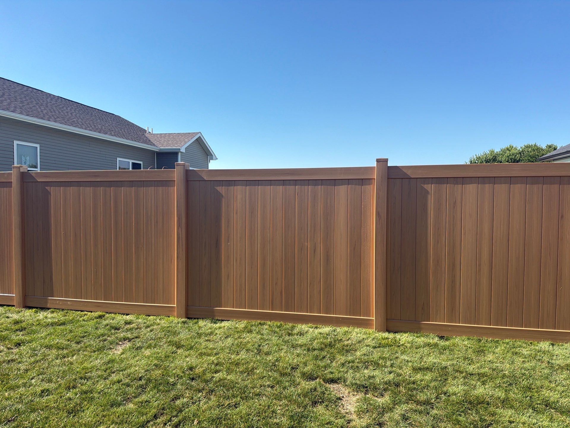 Residential Cypress Vinyl Privacy Fence Installation in Cedar Falls by Perfect Picket Fence and Stain