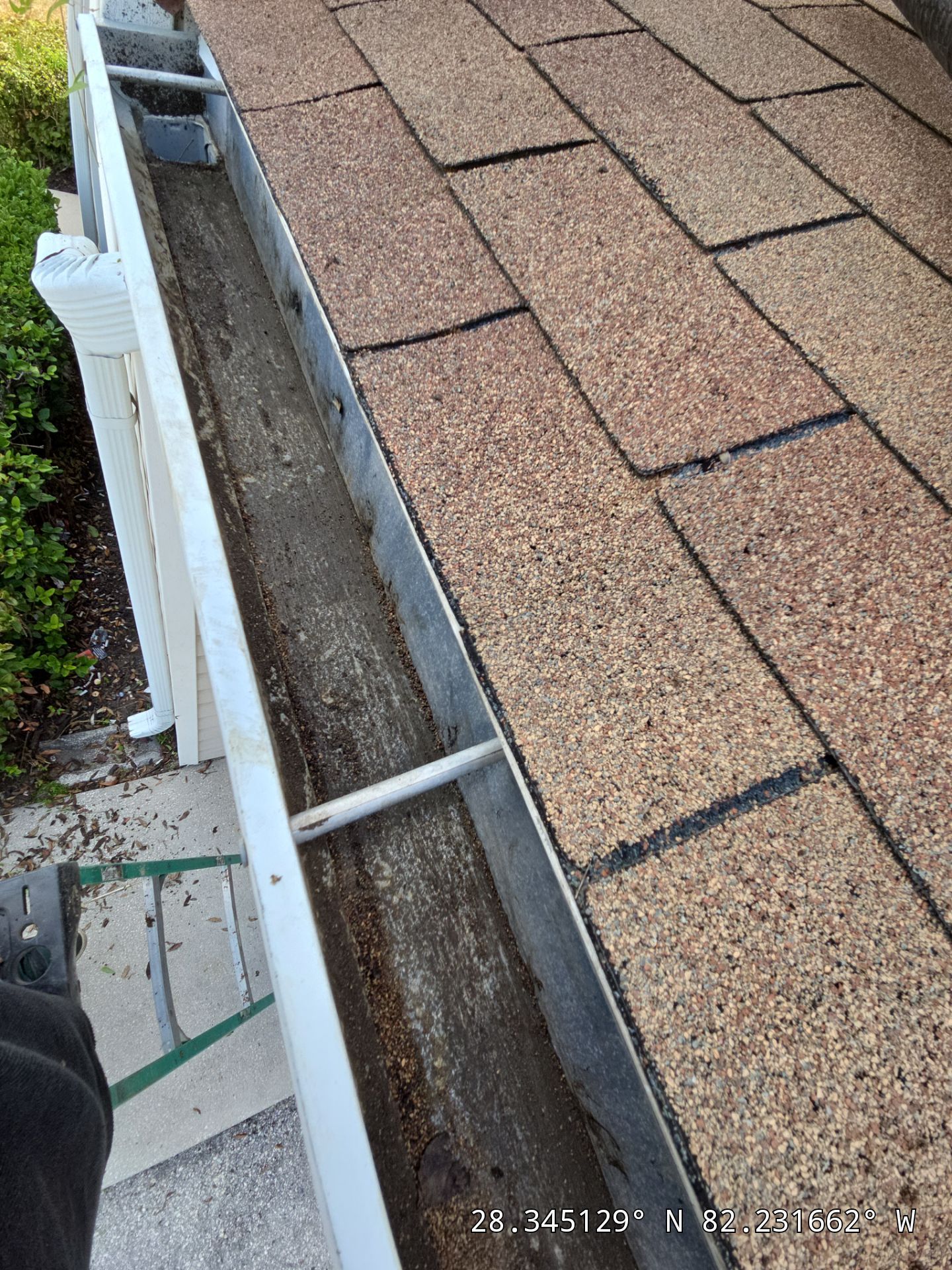 HOA gutter cleaning in Spring Hill, after  photo showing full gutters.