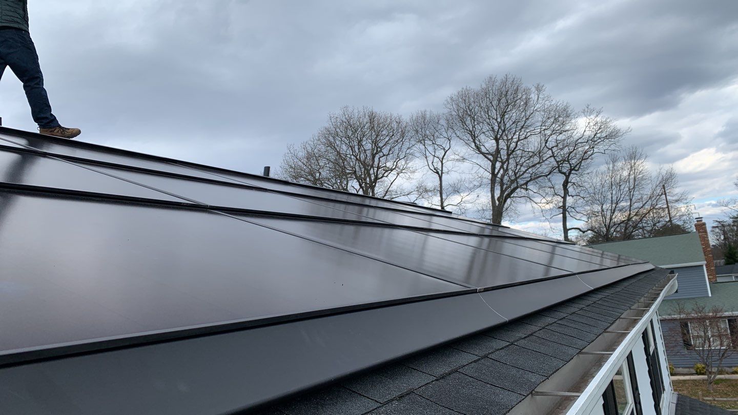 Roof Replacement with GAF Decotech integrated solar panels by American Home Contractors