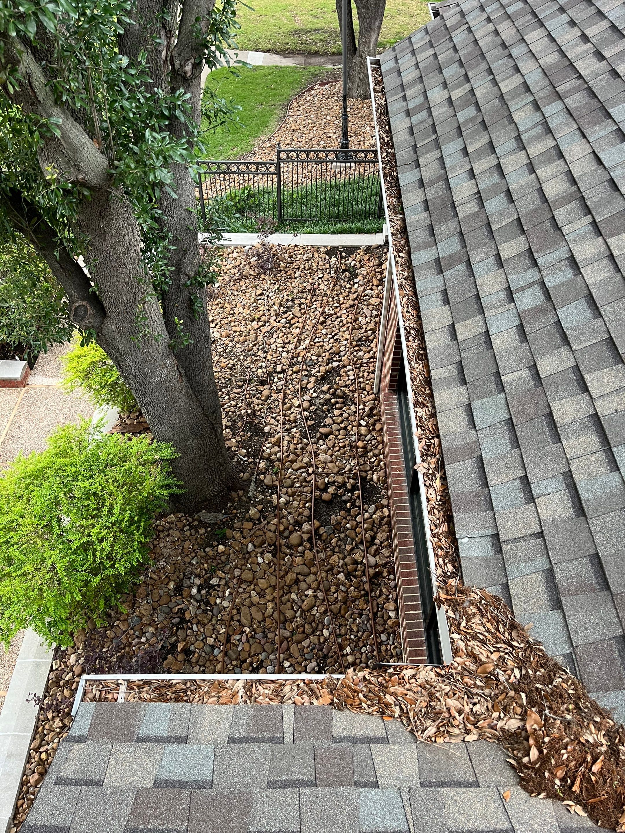 HOA gutter cleaning in Allen, TX,before  photo showing full gutters.