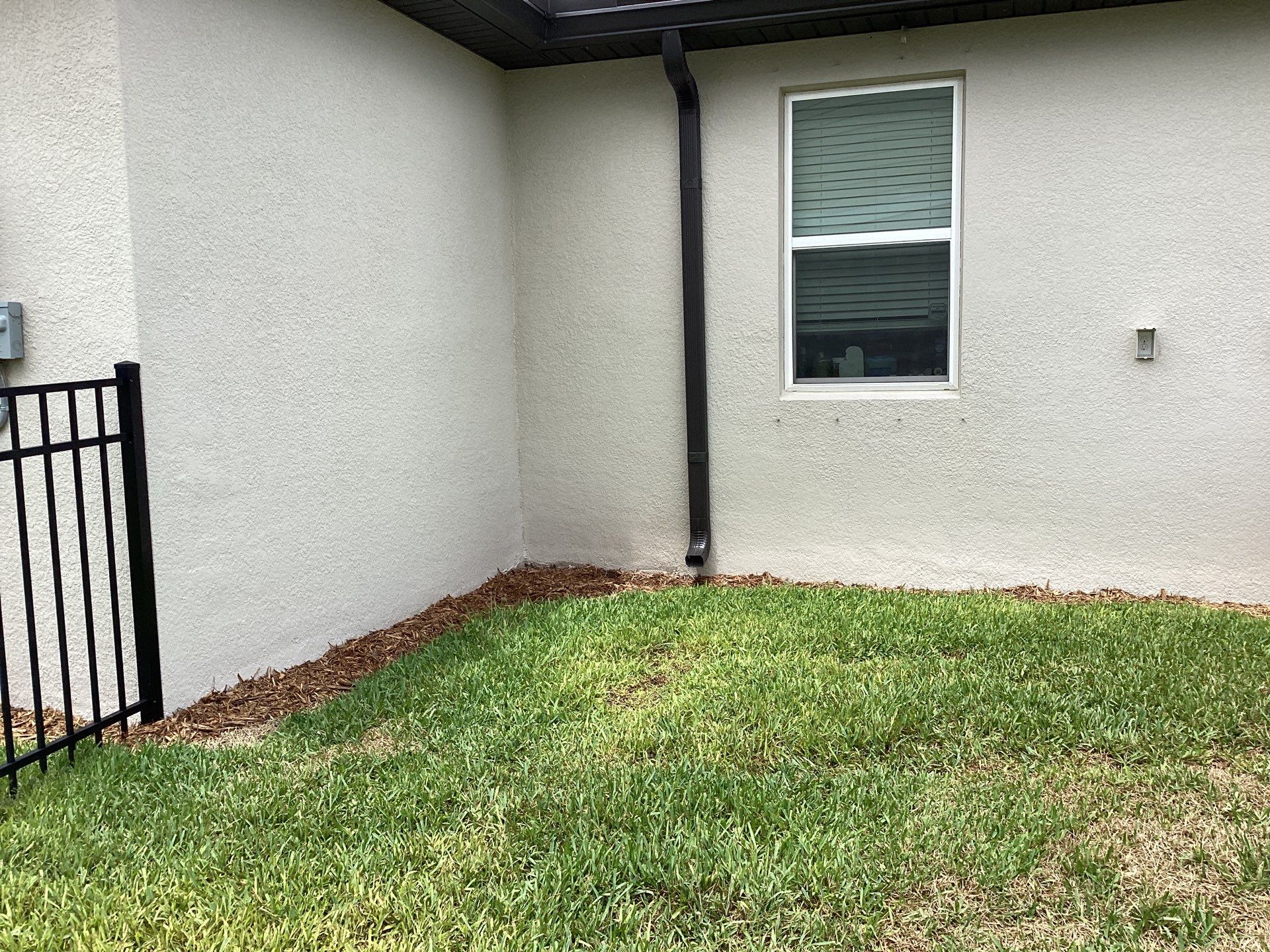 Musket brown seamless gutters with splash guards, new downspouts, and extensions in Bradenton, FL by Gutter Professors