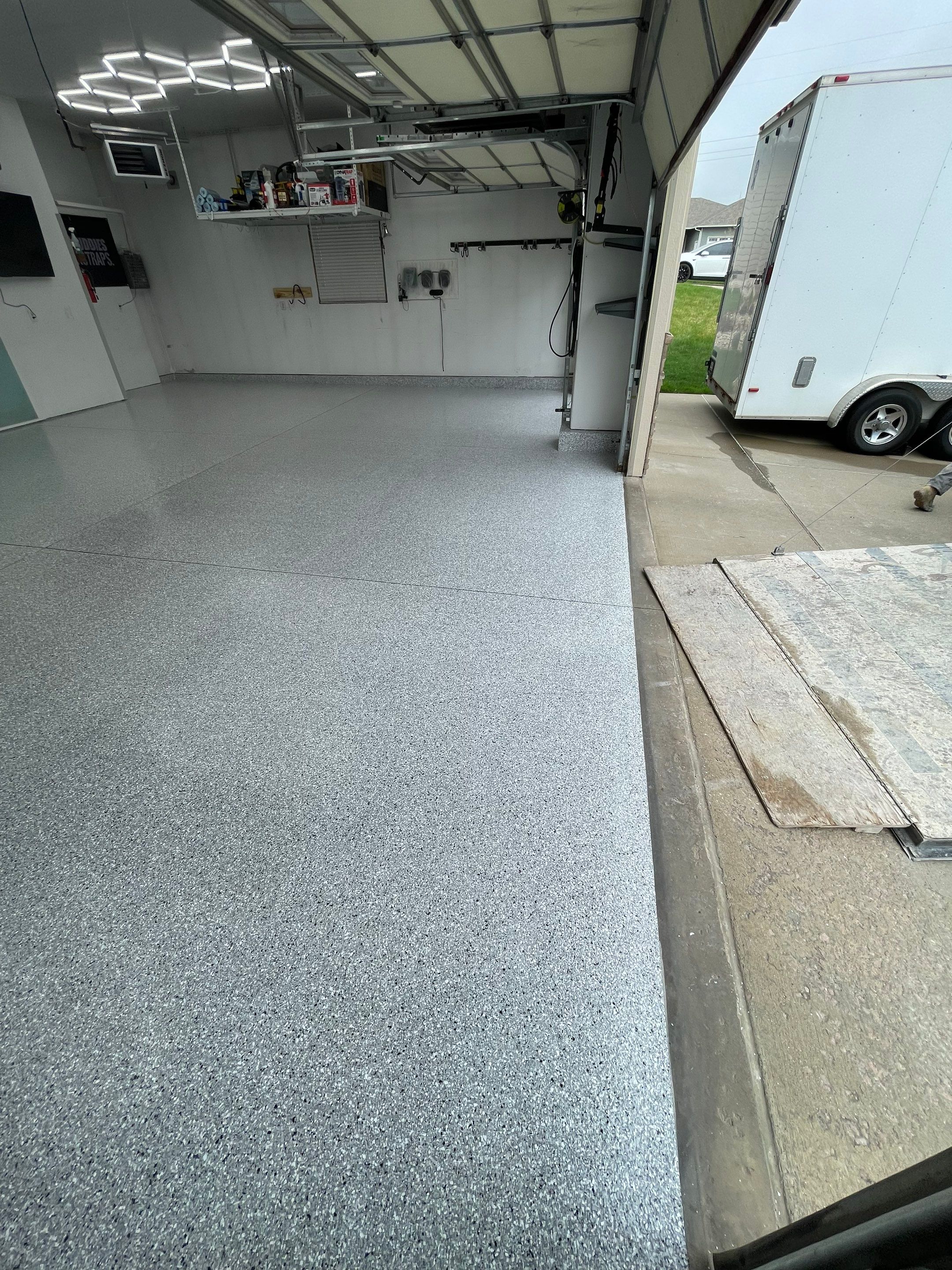 Feather Gray Epoxy Floor Coating Installation in Sioux Falls by Select Painting, Coatings & Garage Cabinets