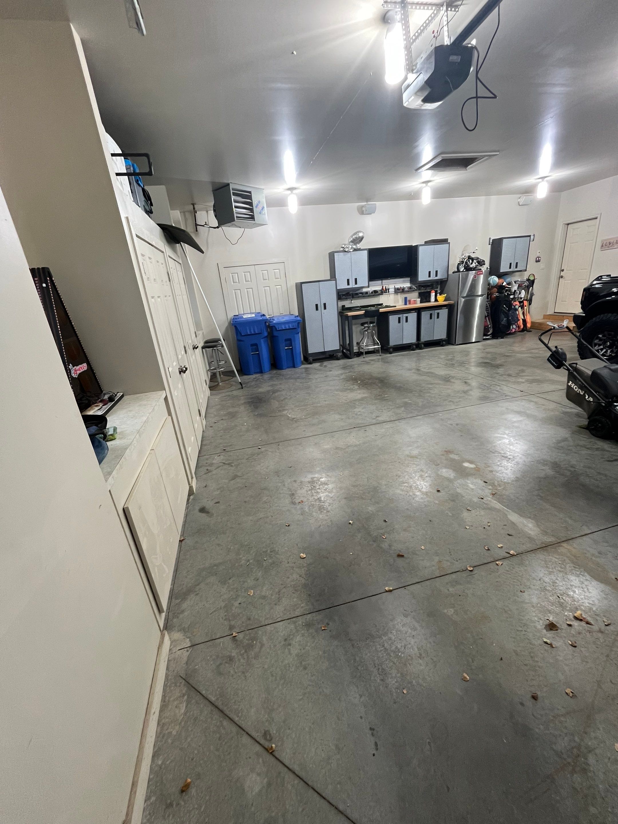 Coyote Flake Garage Floor Coating in Sioux Falls with Trench Drain by Select Painting, Coatings & Garage Cabinets
