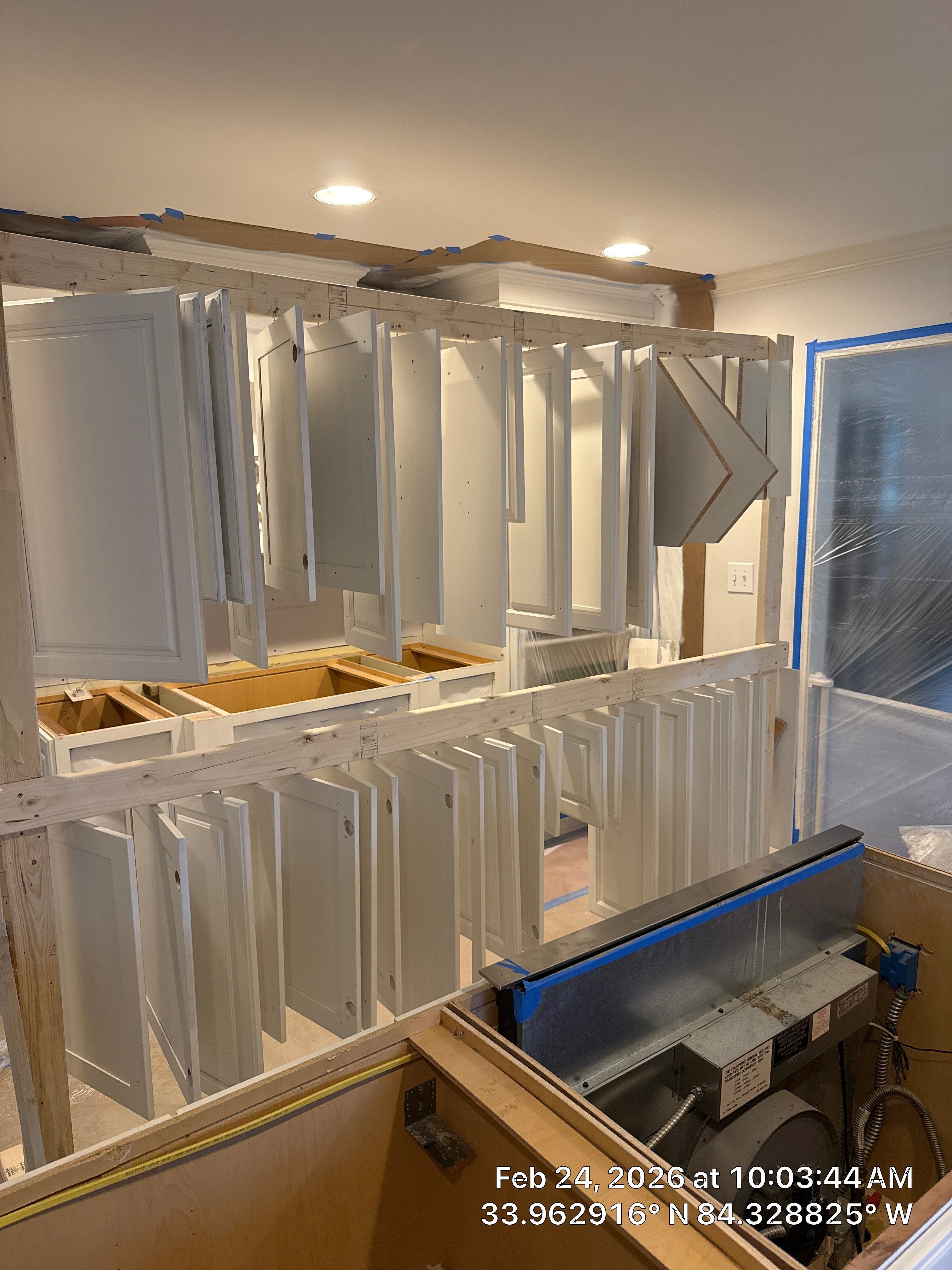 Kitchen Remodel in Dunwoody Featuring White Cabinetry and Blue Island by Heart & Home Kitchen & Bath Remodeling LLC