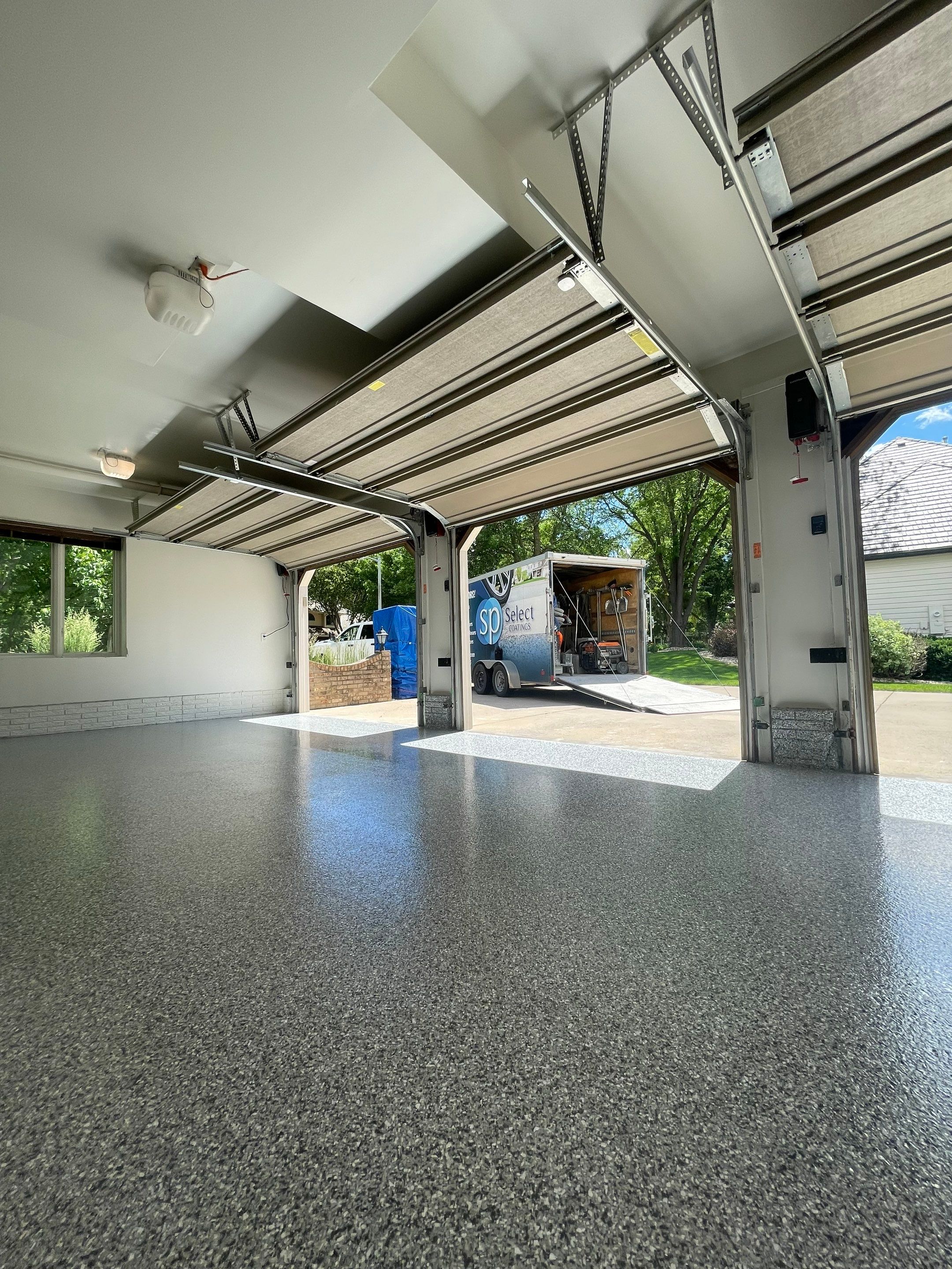 Gray Speckled Epoxy Garage Floor Coating in Sioux Falls by Select Painting, Coatings & Garage Cabinets