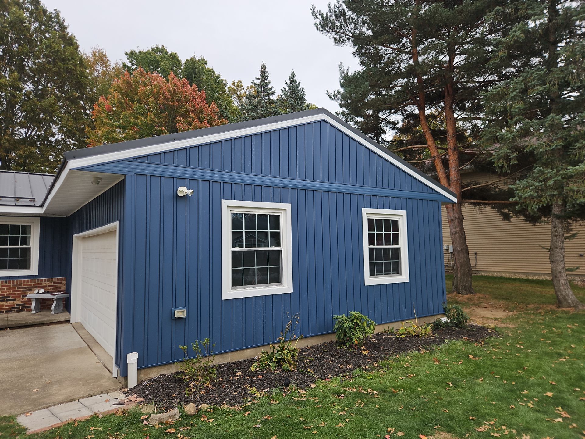 Wadsworth Exterior Transformation Featuring Blue Vertical Siding and Metal Roofing by Cornerstone Roofing And Siding