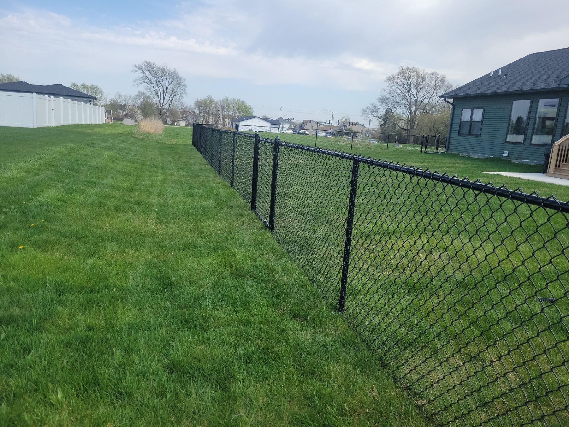 Black Chain Link Fence and Gate Installation in Cedar Falls by Perfect Picket Fence and Stain
