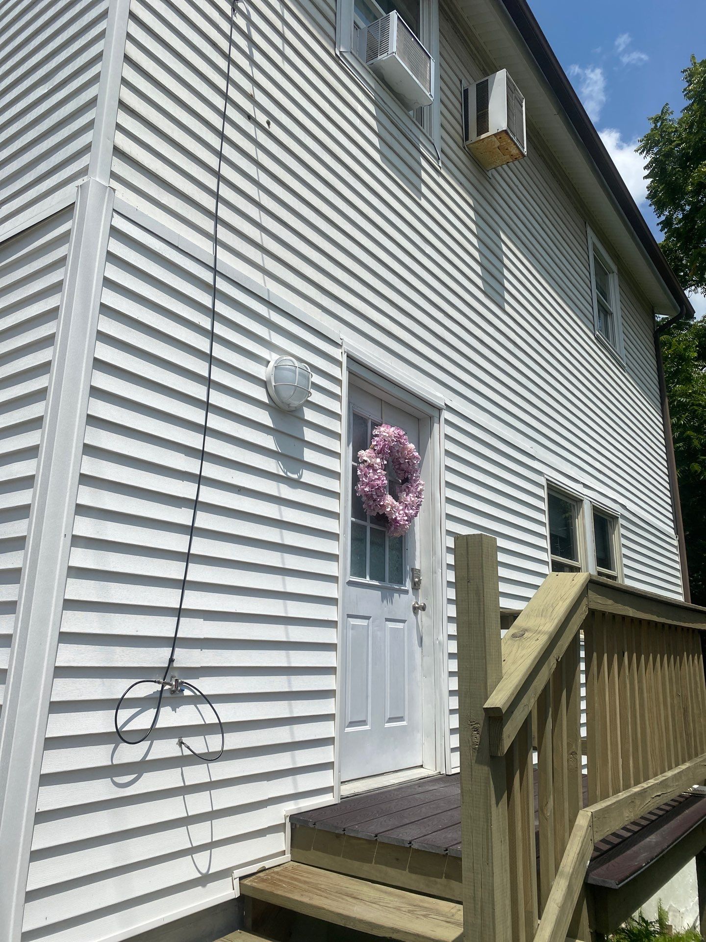 White siding  by Cousins Roofing Siding & Decks