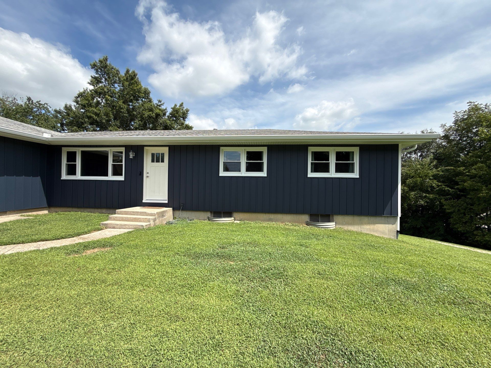 Indigo Board and Batten Siding and Window Replacement in Smithville by EEC Windows, Siding & Roofing