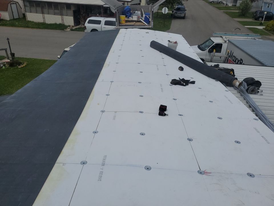 Residential Roofing Installation using 60 mil rubber roof  by Nitro Roofing and Construction
