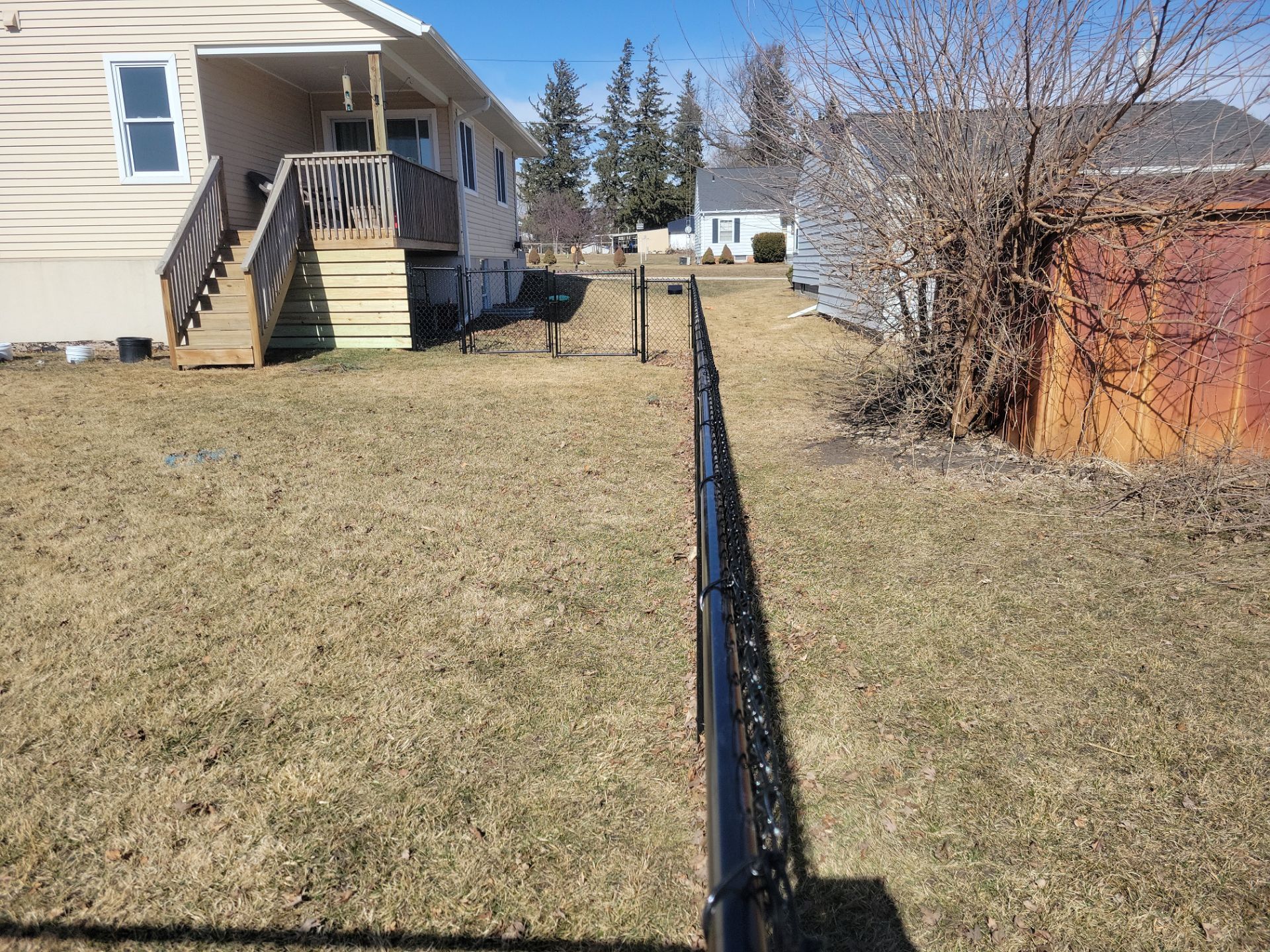 Residential Black Chain Link Fence and Gate Installation in Tripoli by Perfect Picket Fence and Stain