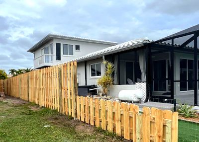 Wood Fence Installation using 6Ft Tall Pressure Treated Wood Shadowbox Fence