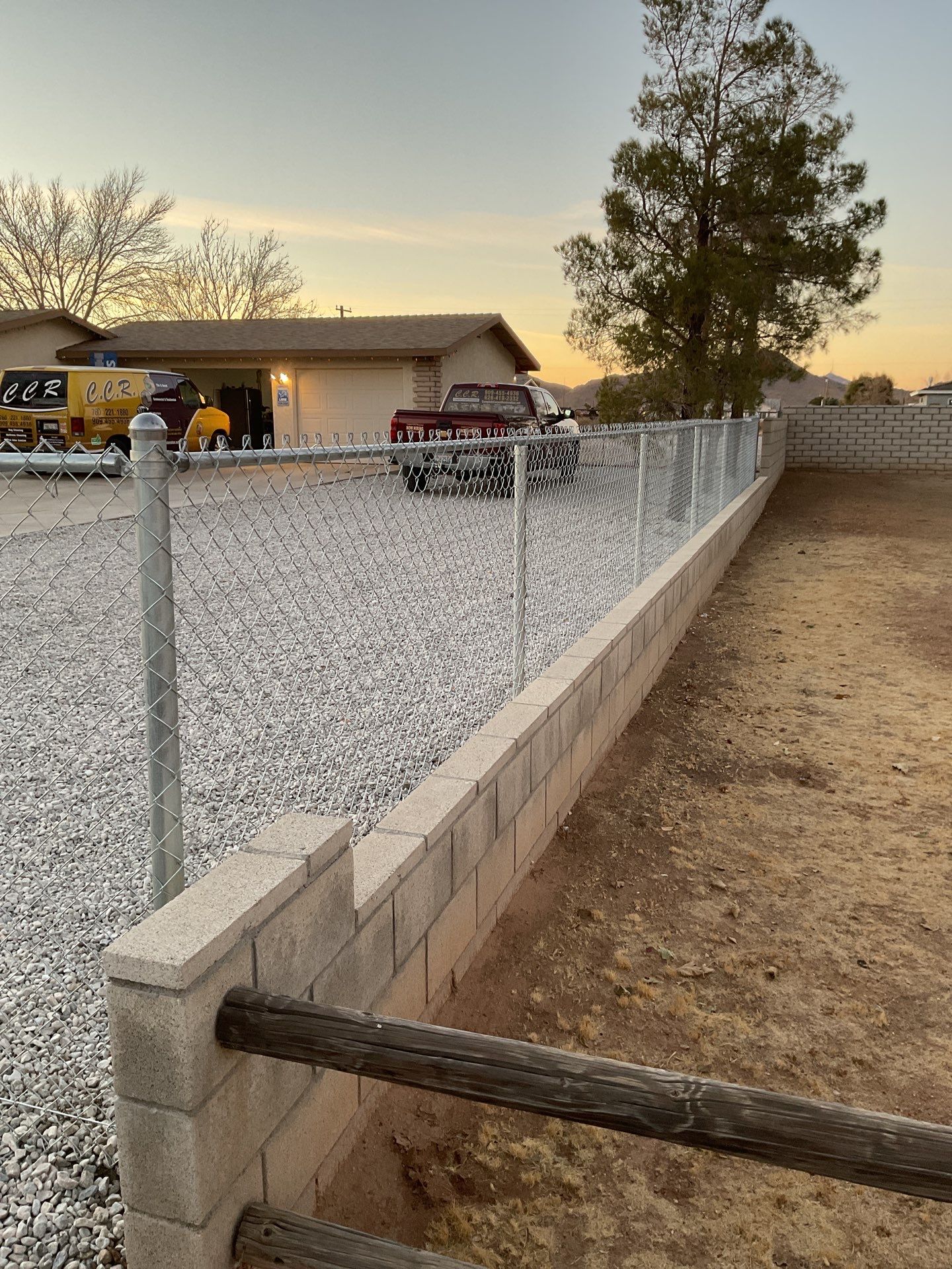 Sleek chain link fence installation with a solar motorized gate by Fence Guys Inc.