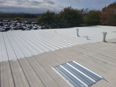 Wide angle of a finished white metal roof coating