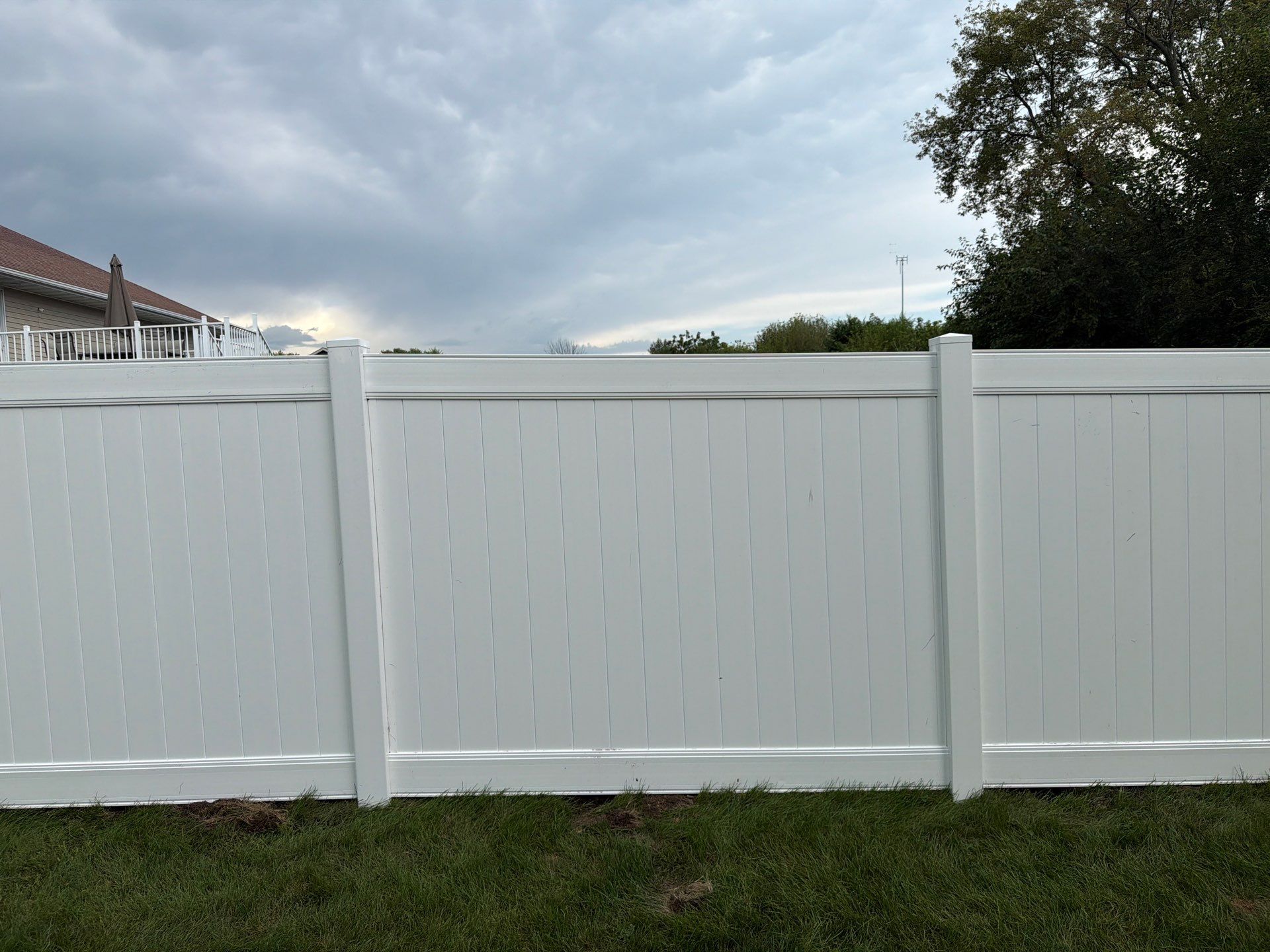 White Vinyl Privacy Fence Installation in Raymond, IA by Perfect Picket Fence and Stain