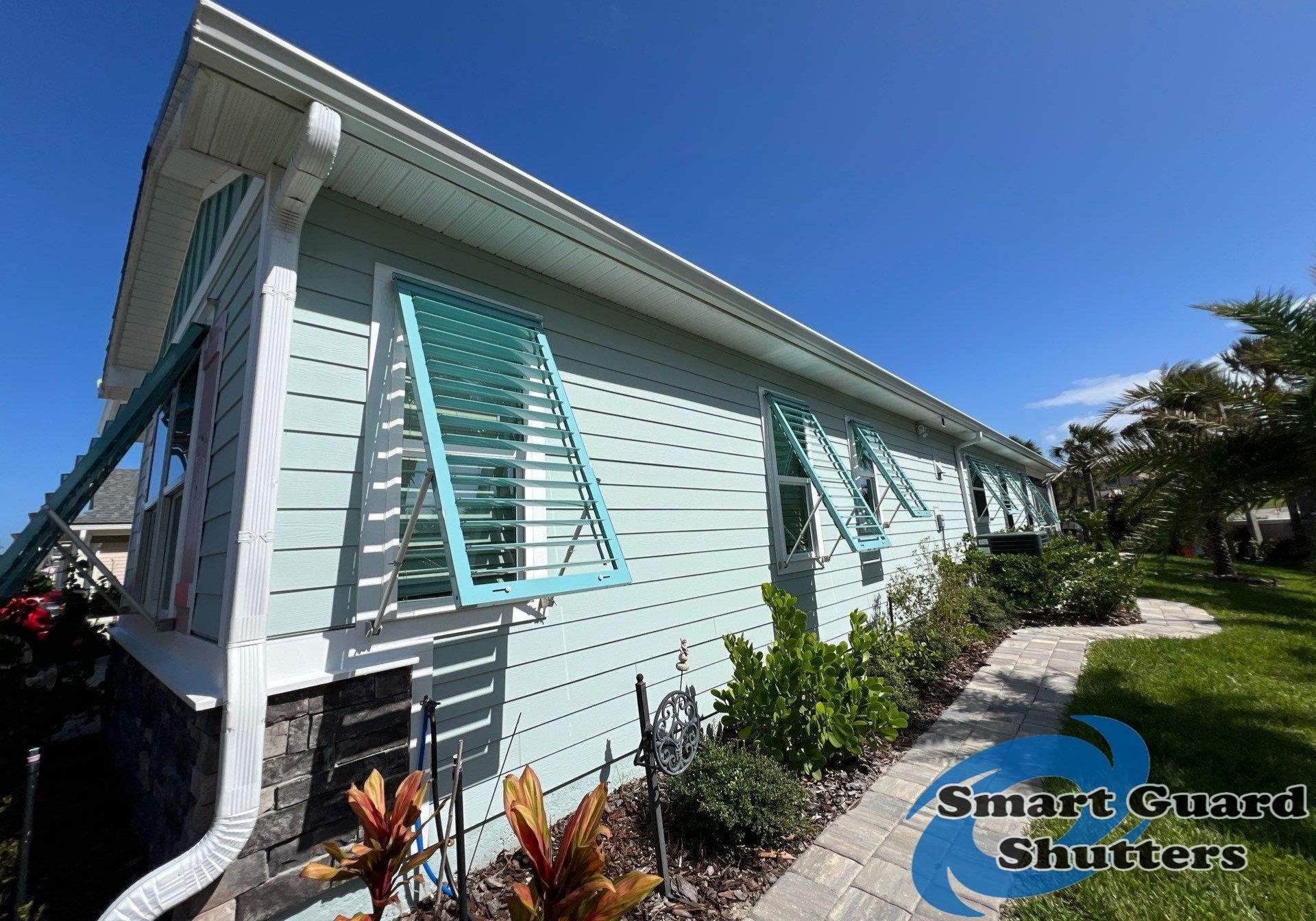 Impact Bahama Shutters in Pastel Turquoise by Smart Guard Shutters