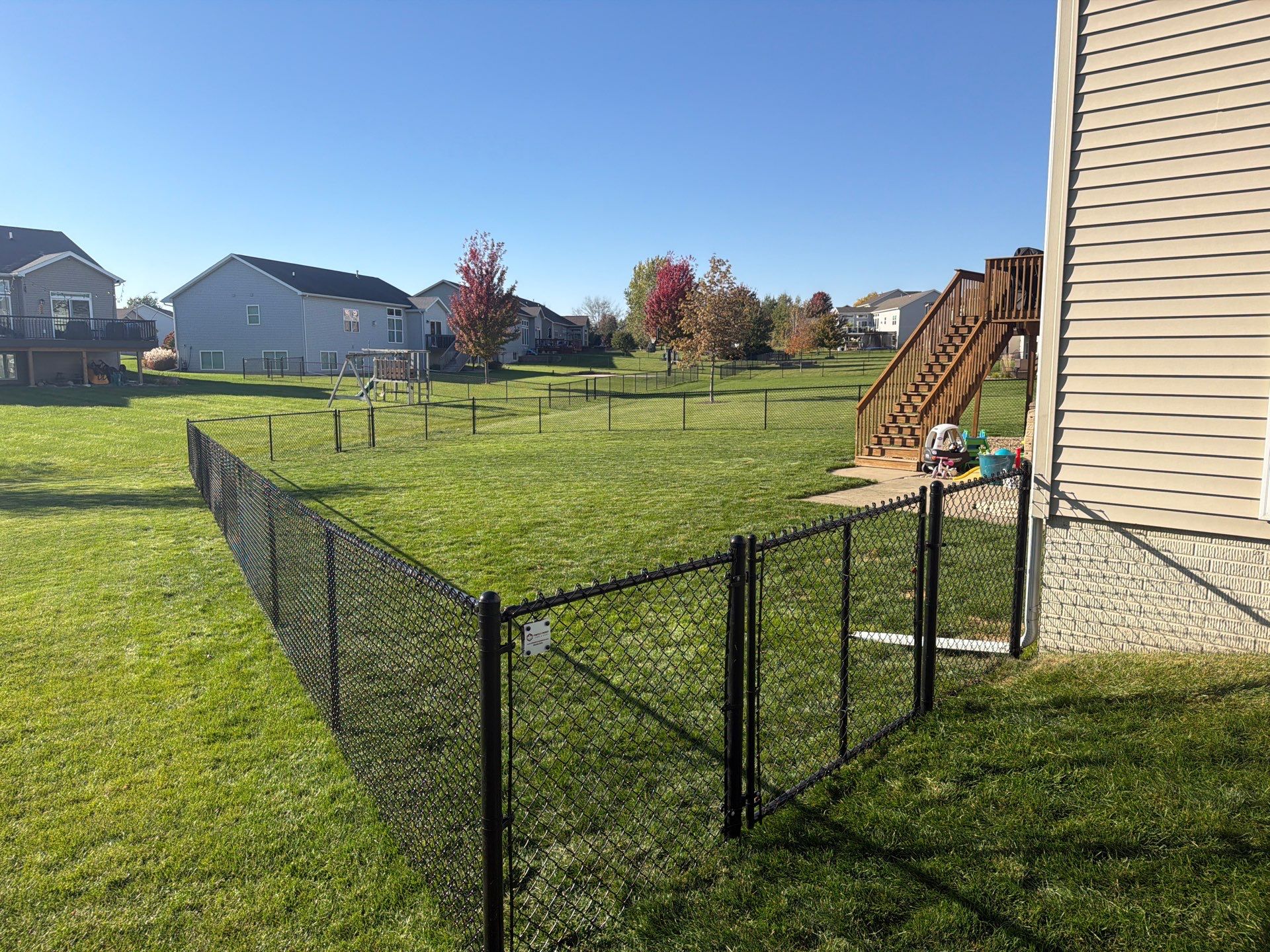 Black Vinyl-Coated Chain Link Fence Installation in Cedar Falls by Perfect Picket Fence and Stain