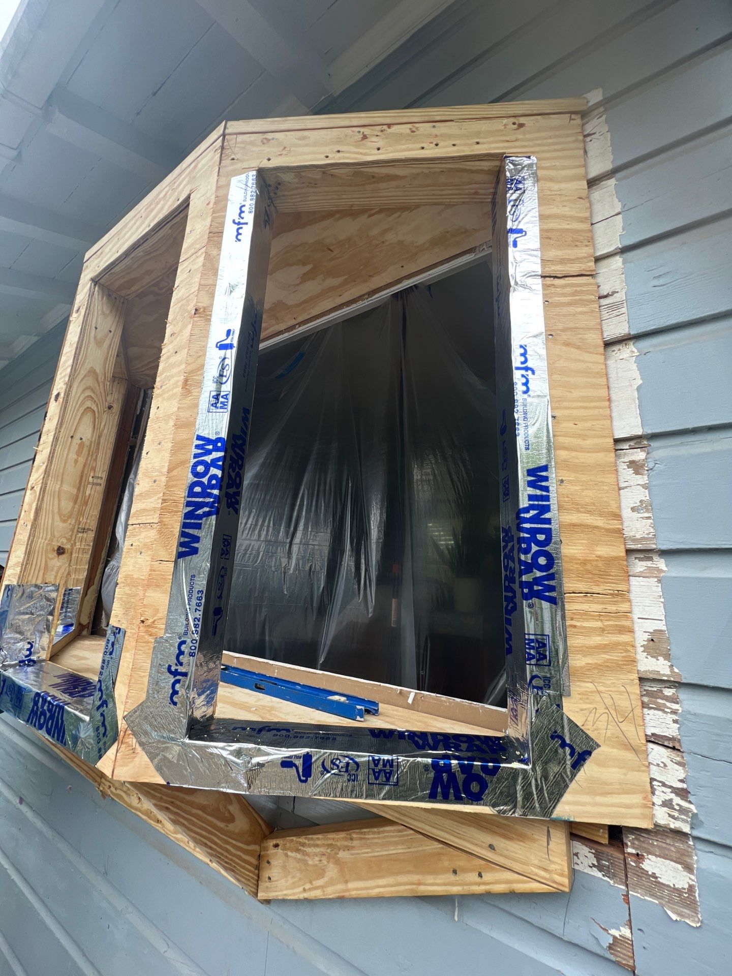 Installing Windows on a Submarine  by Bayfront Roofing and Construction