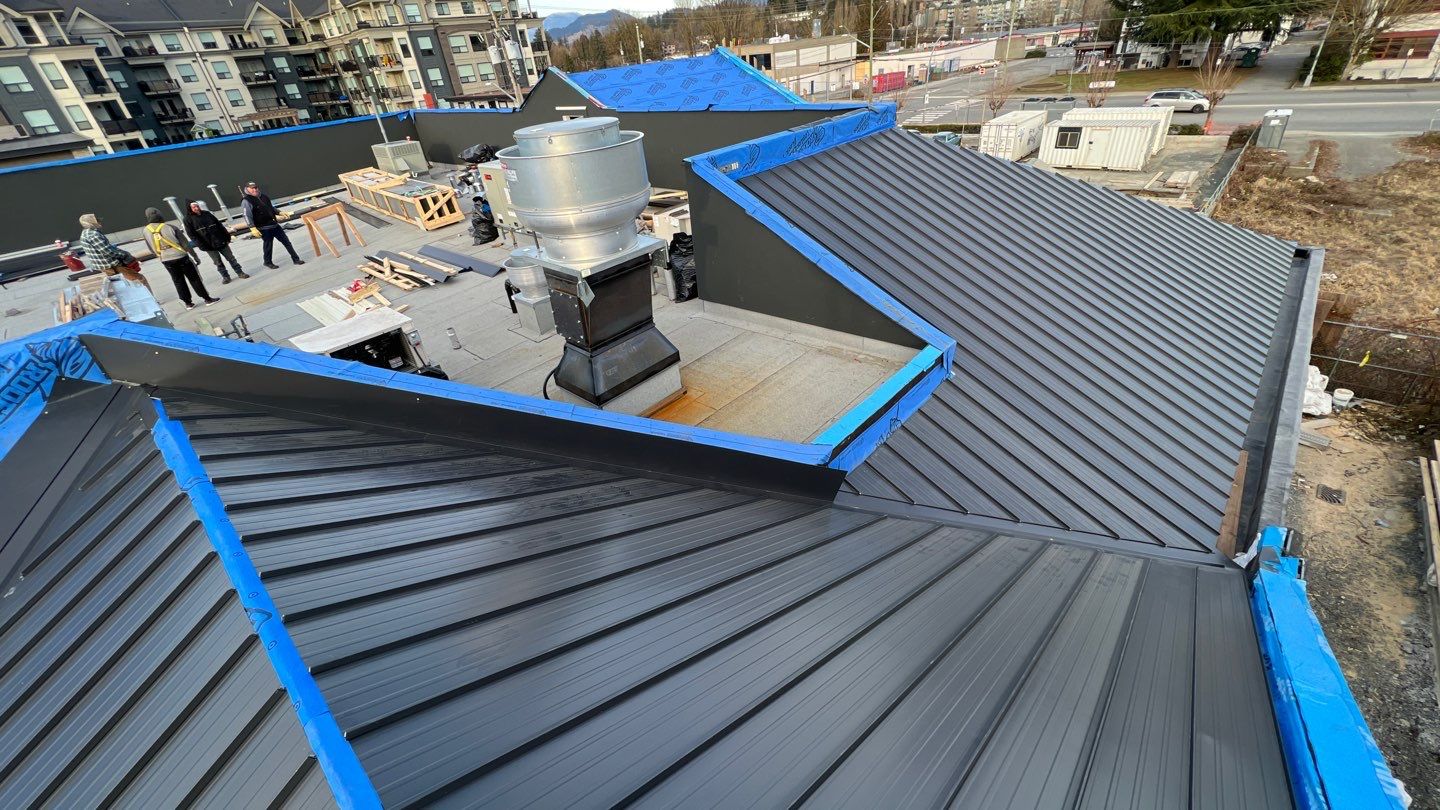 Commercial Roofing Installation using 12" Prolok metal and hidden gutters! by Top Notch Roofing Inc