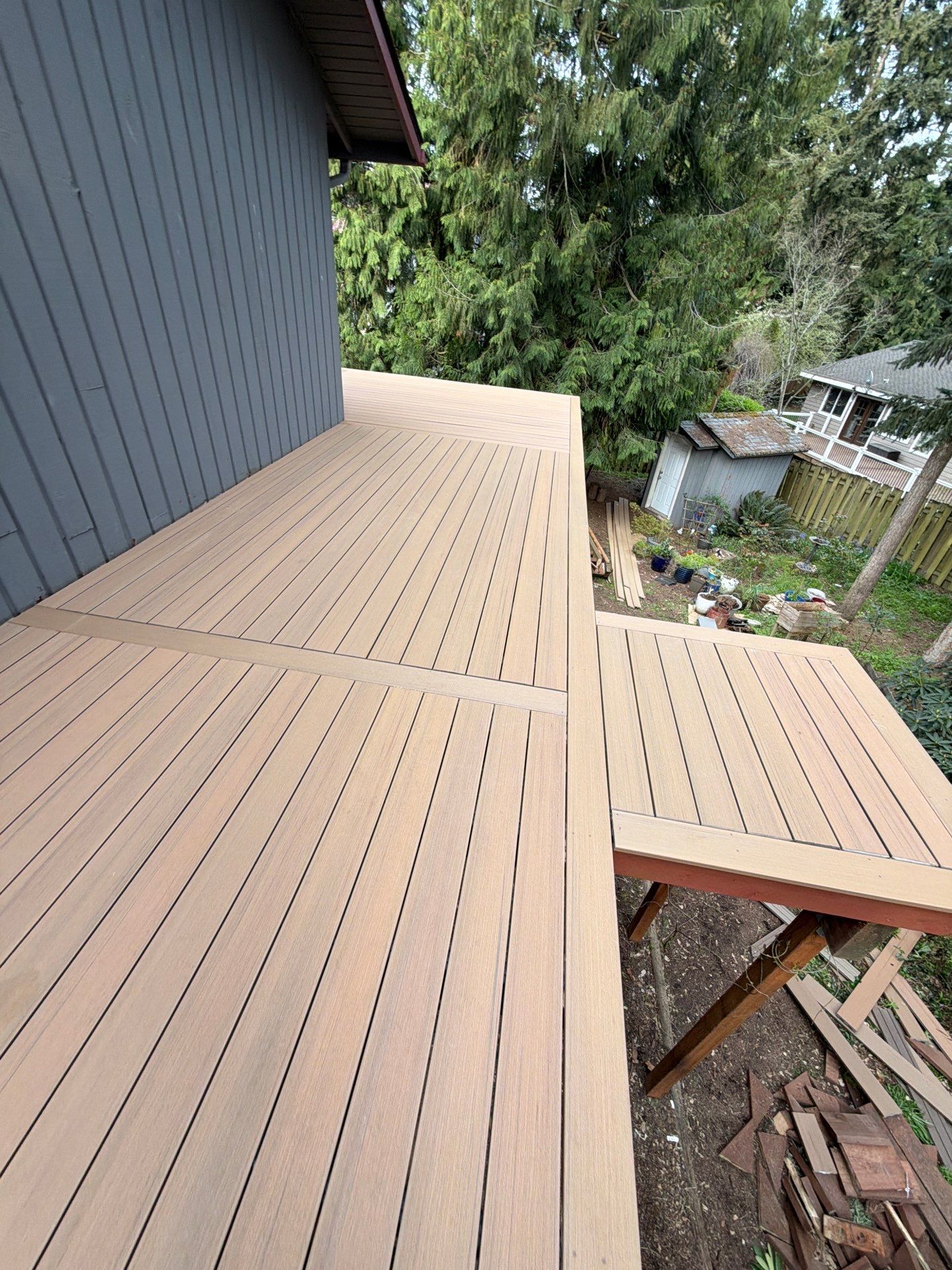 Elevated TimberTech Composite Deck Replacement With Black Metal Railings by Emerald City Energy