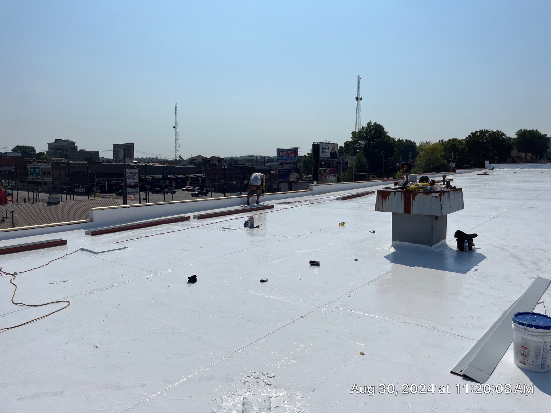 Commercial Roofing Installation using smartcoat Roof coating by Fahey Roofing + Contracting