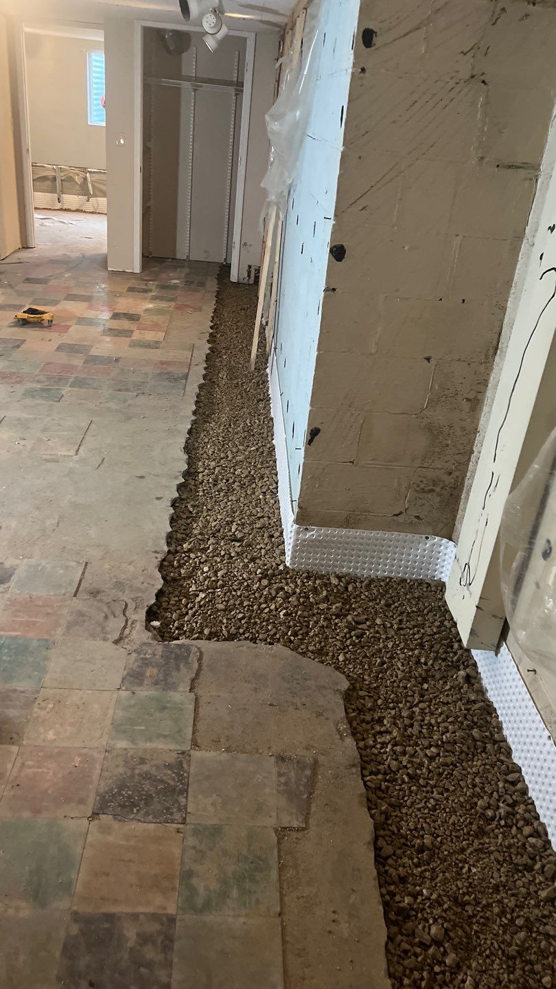 Interior drain tile system installation by ACE Waterproofing & Basement Solutions