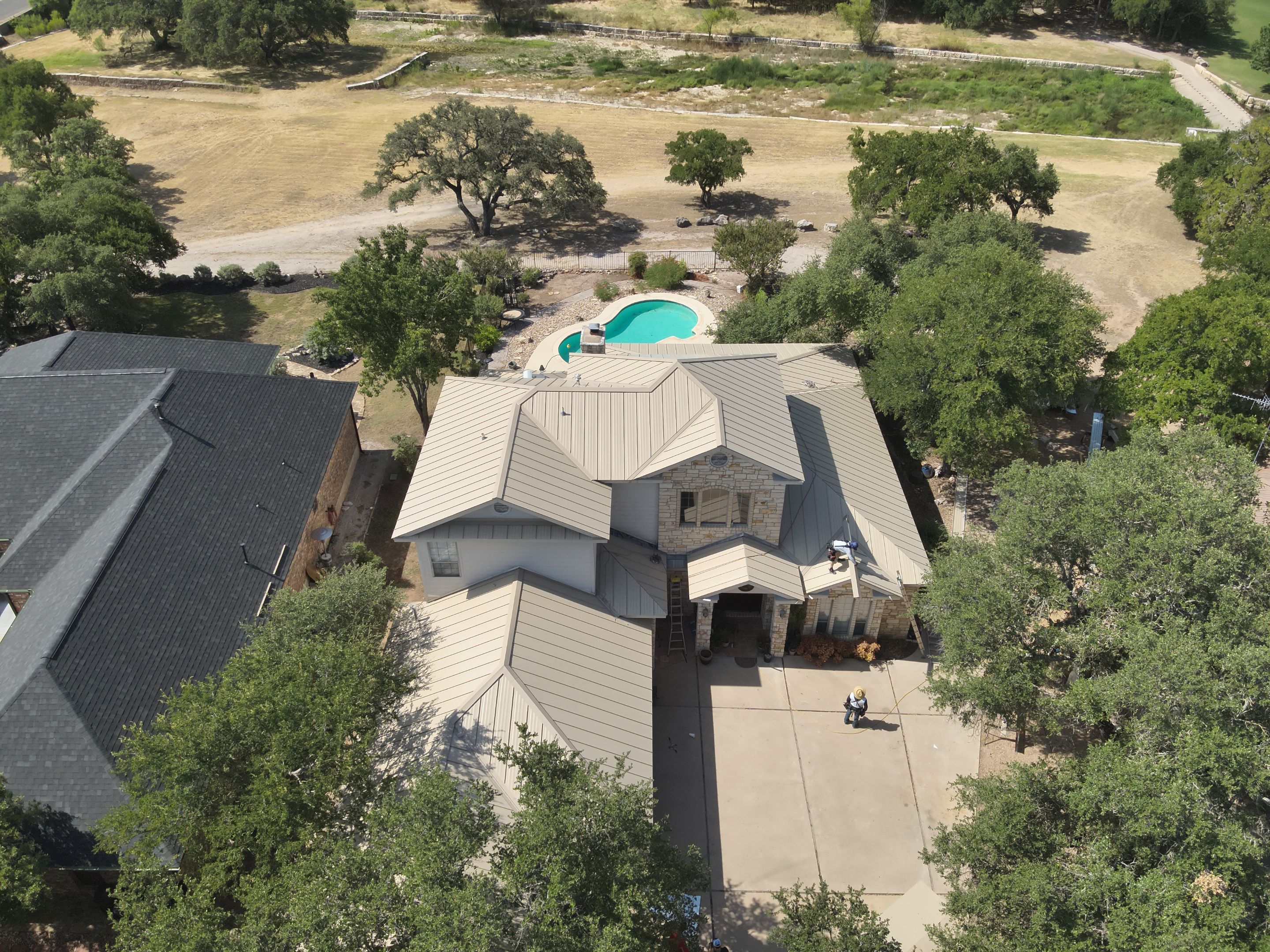 Residential Roof Replacement using 24 GA Double-Lock - Surrey Beige by Action Exteriors Austin