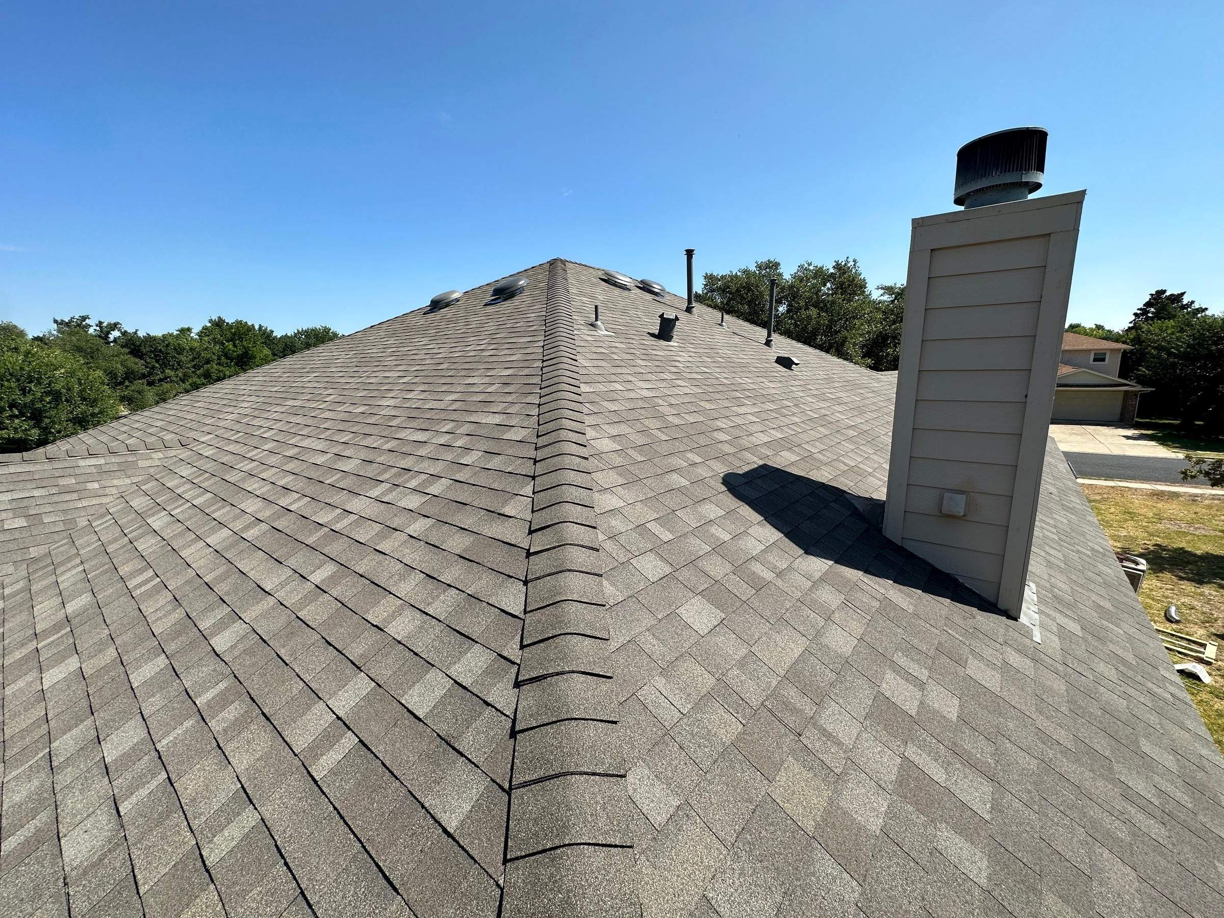 Driftwood Oakridge Roofing at a Round Rock Brick Home by Skywall Construction LLC