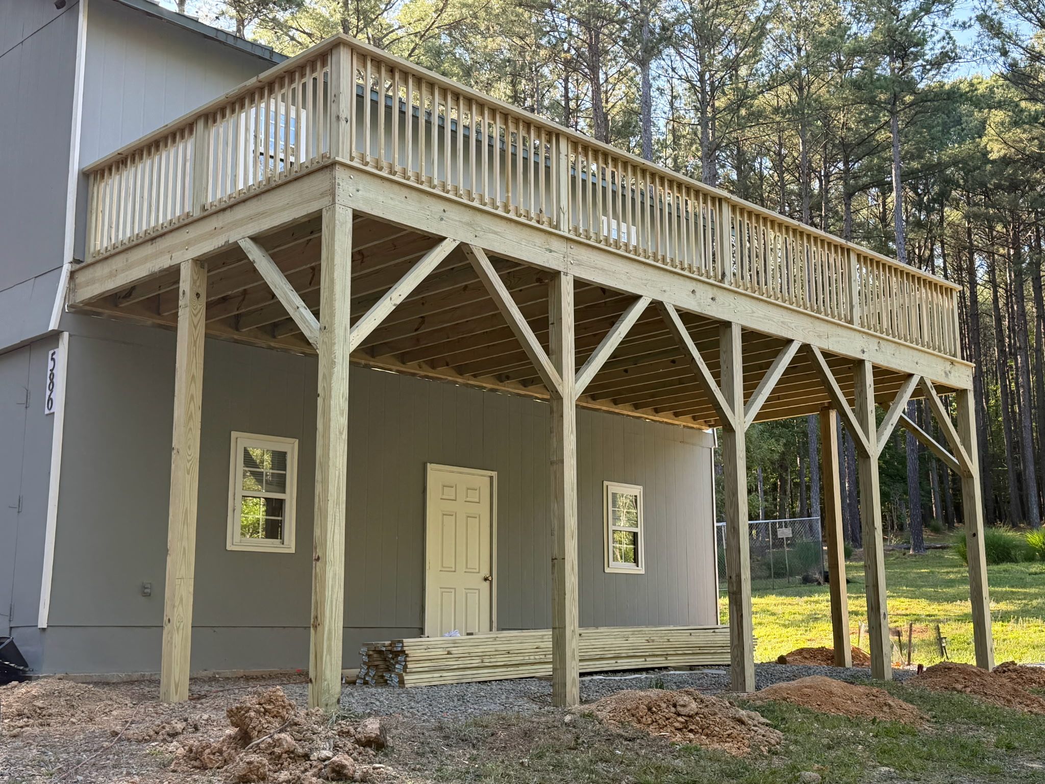 Pittsboro Outdoor Living Transformation – Retaining Wall, Paver Patio & Elevated Deck by Elite Remodeling and Design LLC