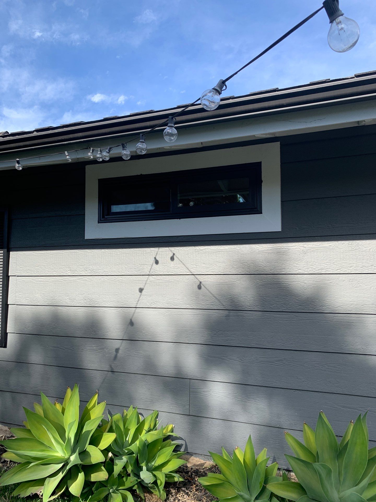 Window Installation using Milgard black vinyl windows by American Window Company
