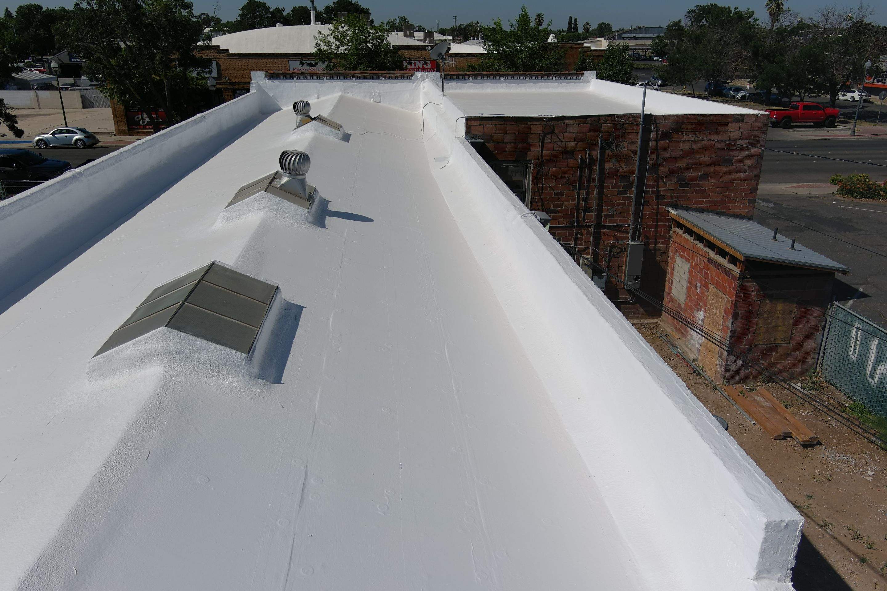 Commercial Roofing Installation using Conklin BenchPly system with PUMA top coat (imbedded fabric system) by Straight Edge Roofing Inc